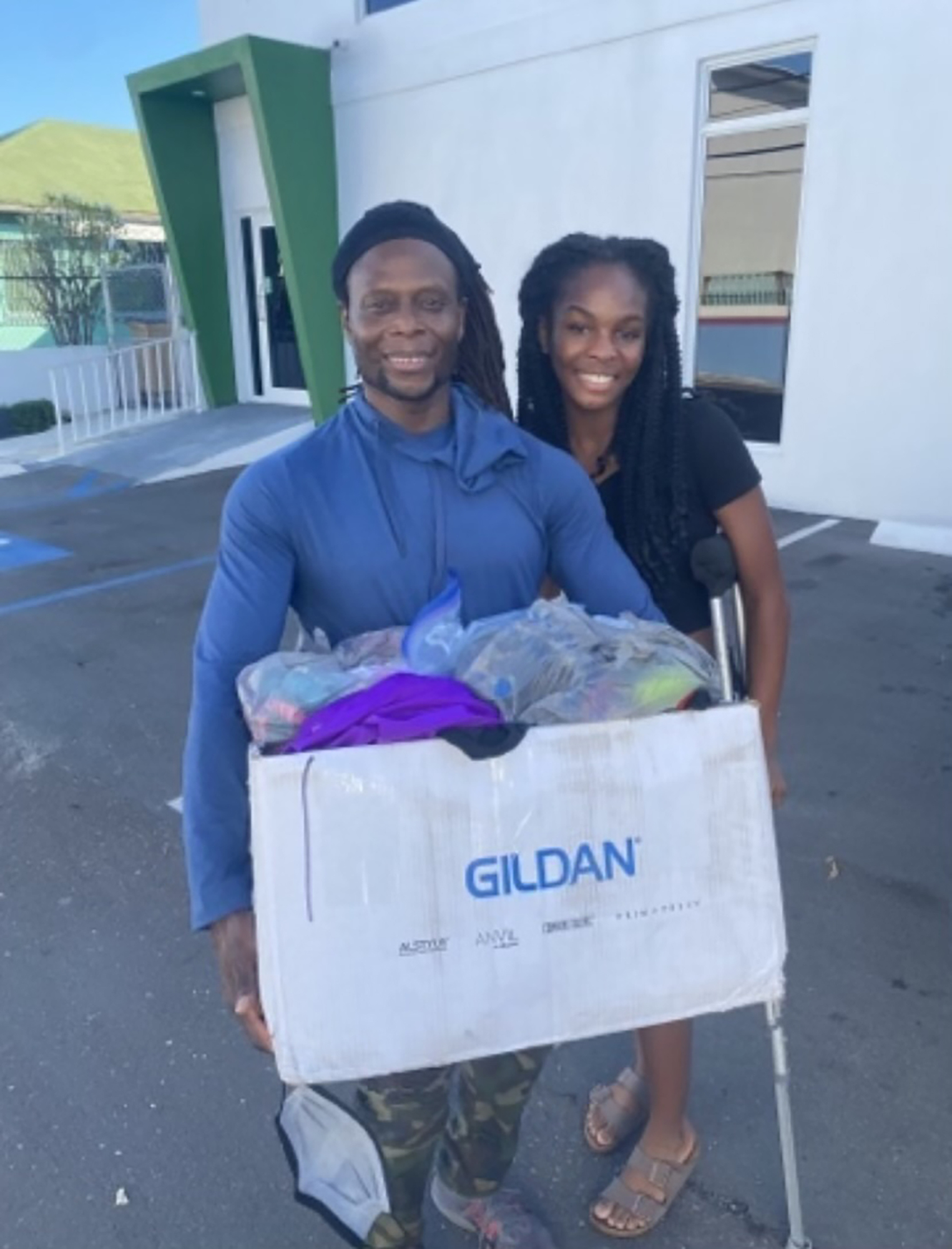 Trevor Ramsey with the Bahamas Gymnastics Federation and owner of Nassau Nastics thanks Rhegan Duncombe, founder of Gymnast to Gymnast, for her donations. Courtesy photo.