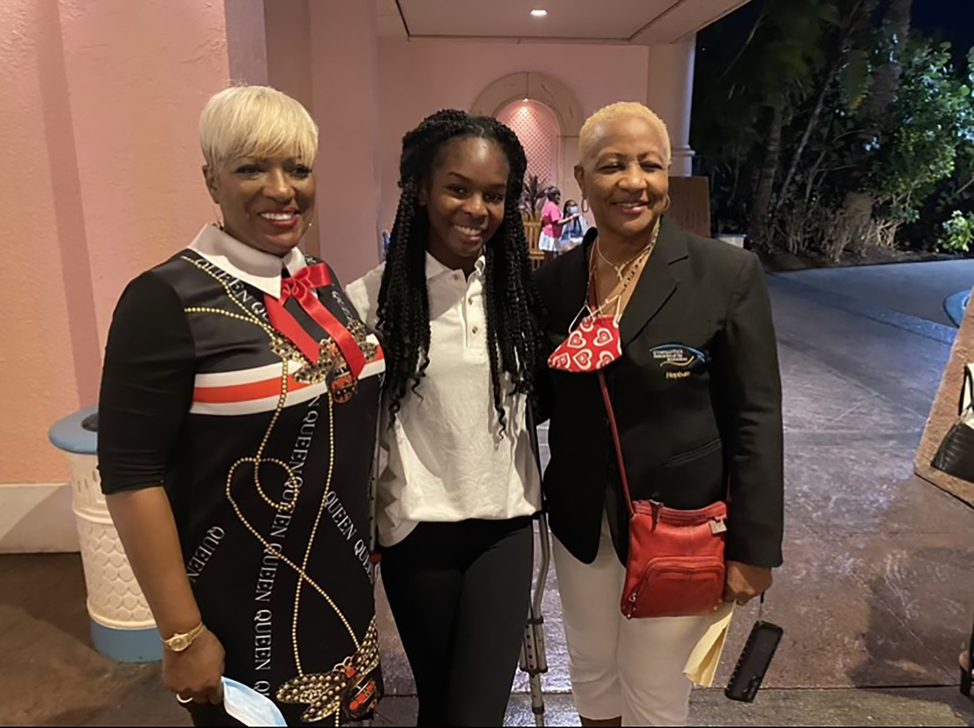Eldece Clarke, the tourism sports director of the Bahamas Ministry of Tourism, and Cora Hepburn, the president of the Bahamas Gymnastics Federation, work with Rhegan Duncombe (center) to support Gymnast to Gymnast. Courtesy photo.