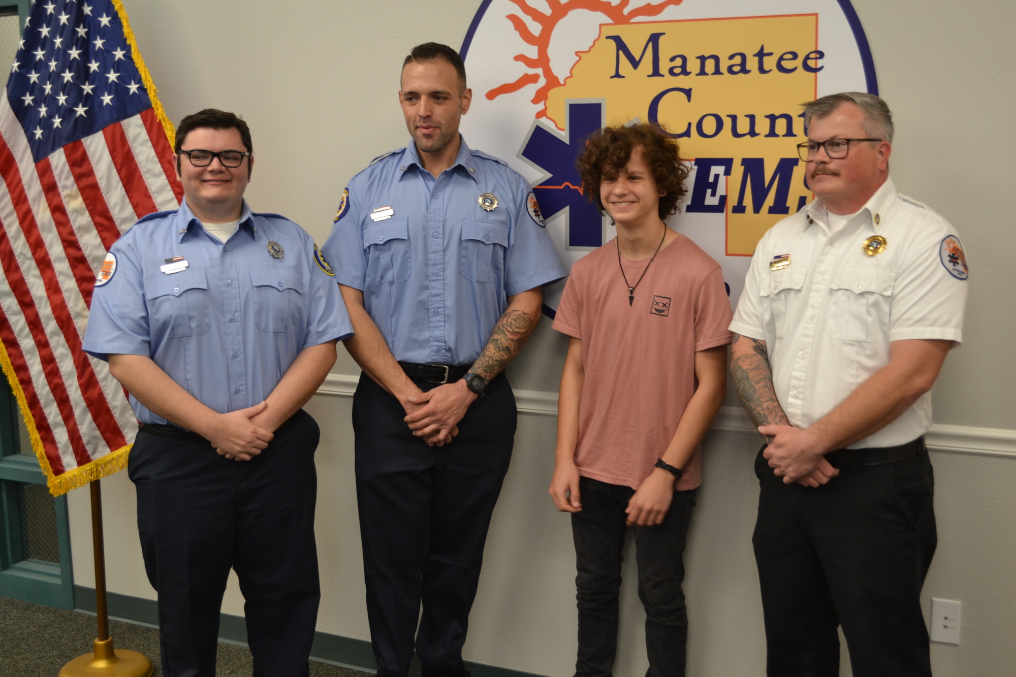 Manatee County Paramedics Nicholas Barion and Chris Roshka, Owen Lockaby, and Manatee County EMS District Chief Christian Ellsworth reunite.