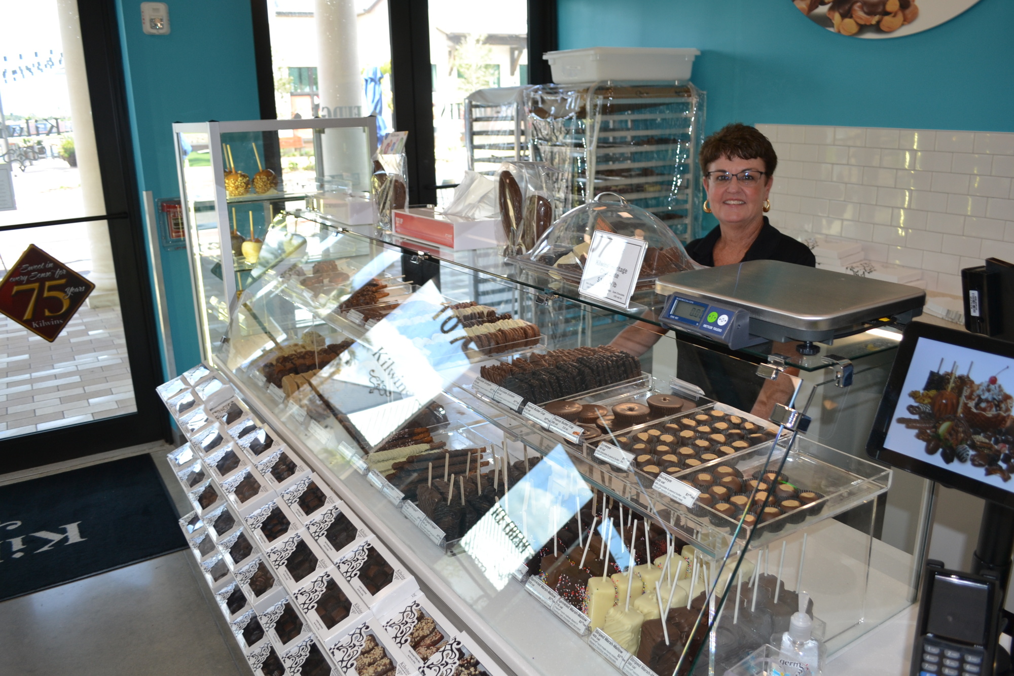 Kate LaBonte stands ready to welcome guests at Kilwins in Waterside Place.