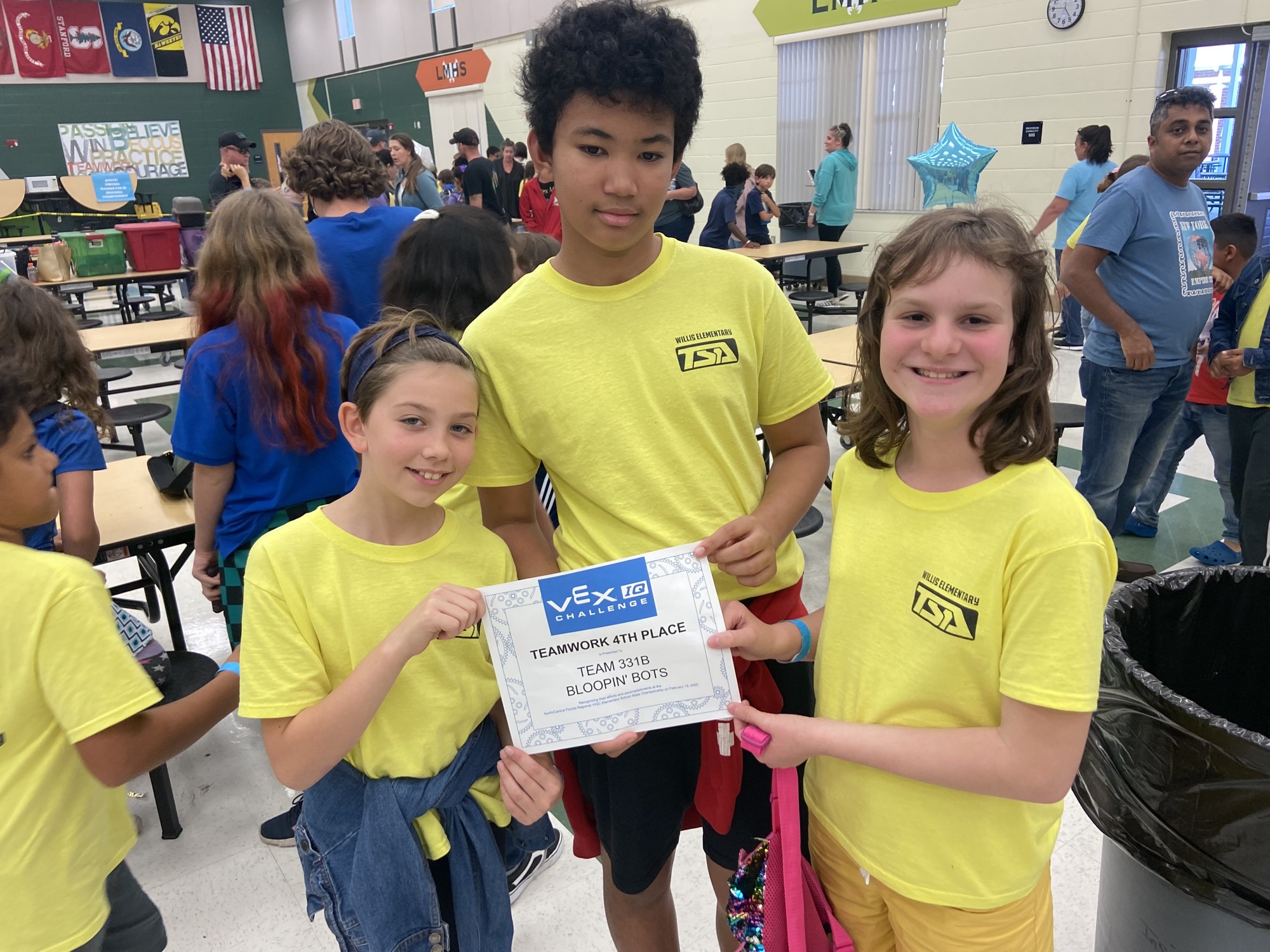Fifth graders Danica Hall, Noah Johnson and Alisa Sabodash celebrate winning fourth place at the VEX Robotics Regional Competition. (Courtesy photo)