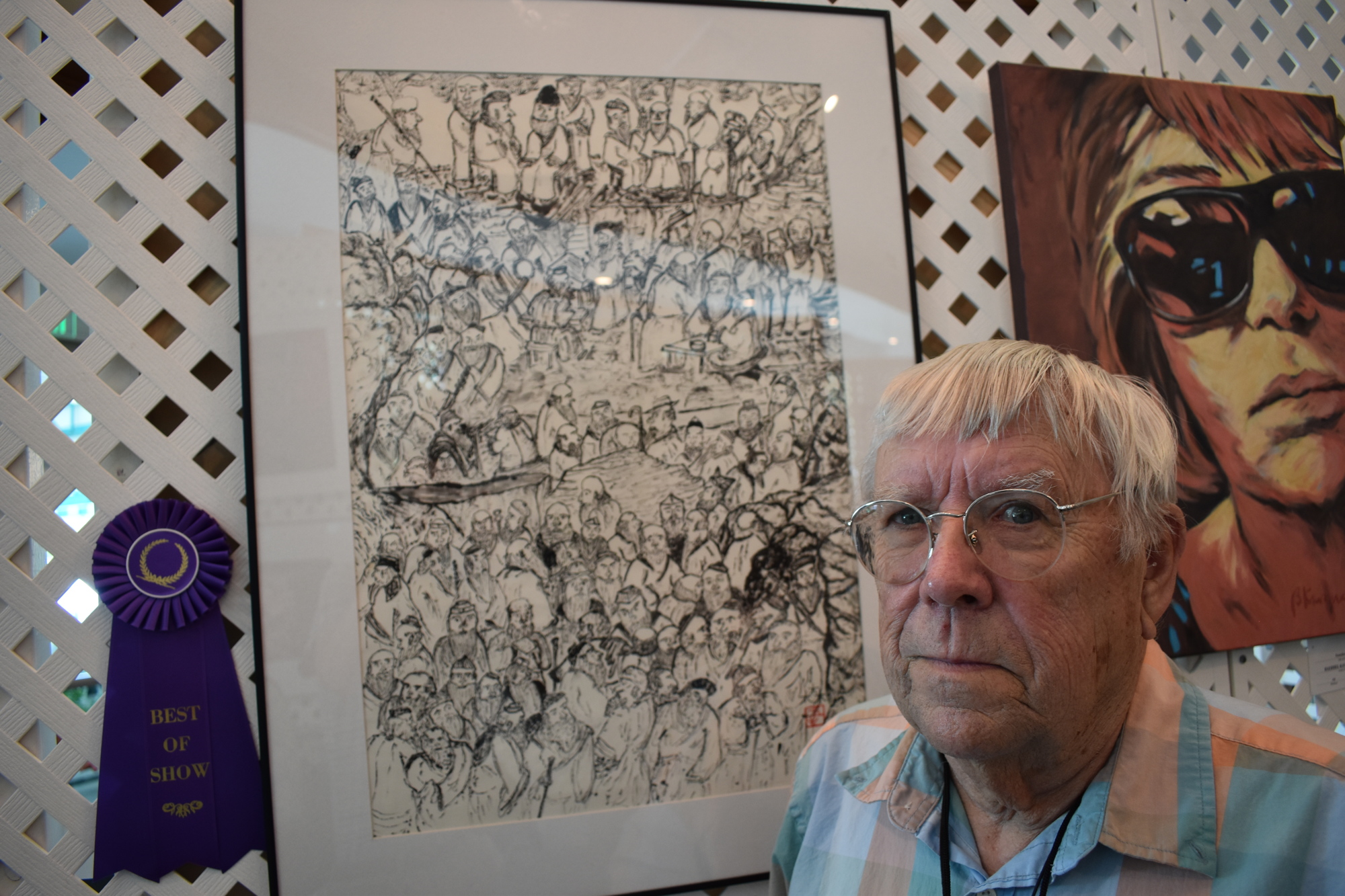 Keith Nelson stands beside his sumi-e ink painting 