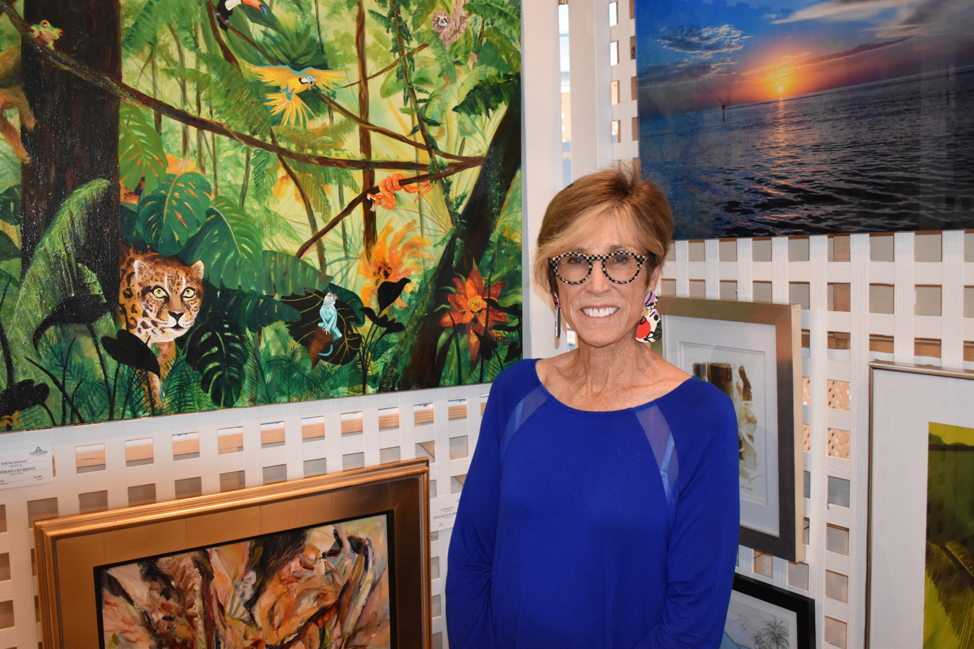 Deborah Van Brunt stands beside her painting (top left) 