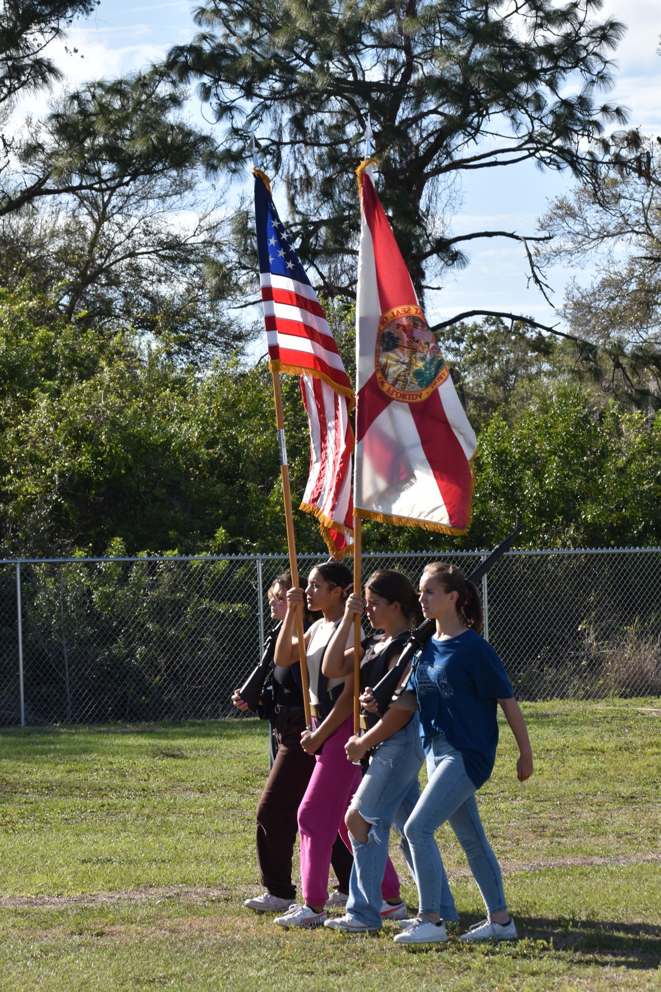 Elayna Andrews, Adonna Wharton, Aurora Skuba, and Julianna Chupp practice marching as the color guard.