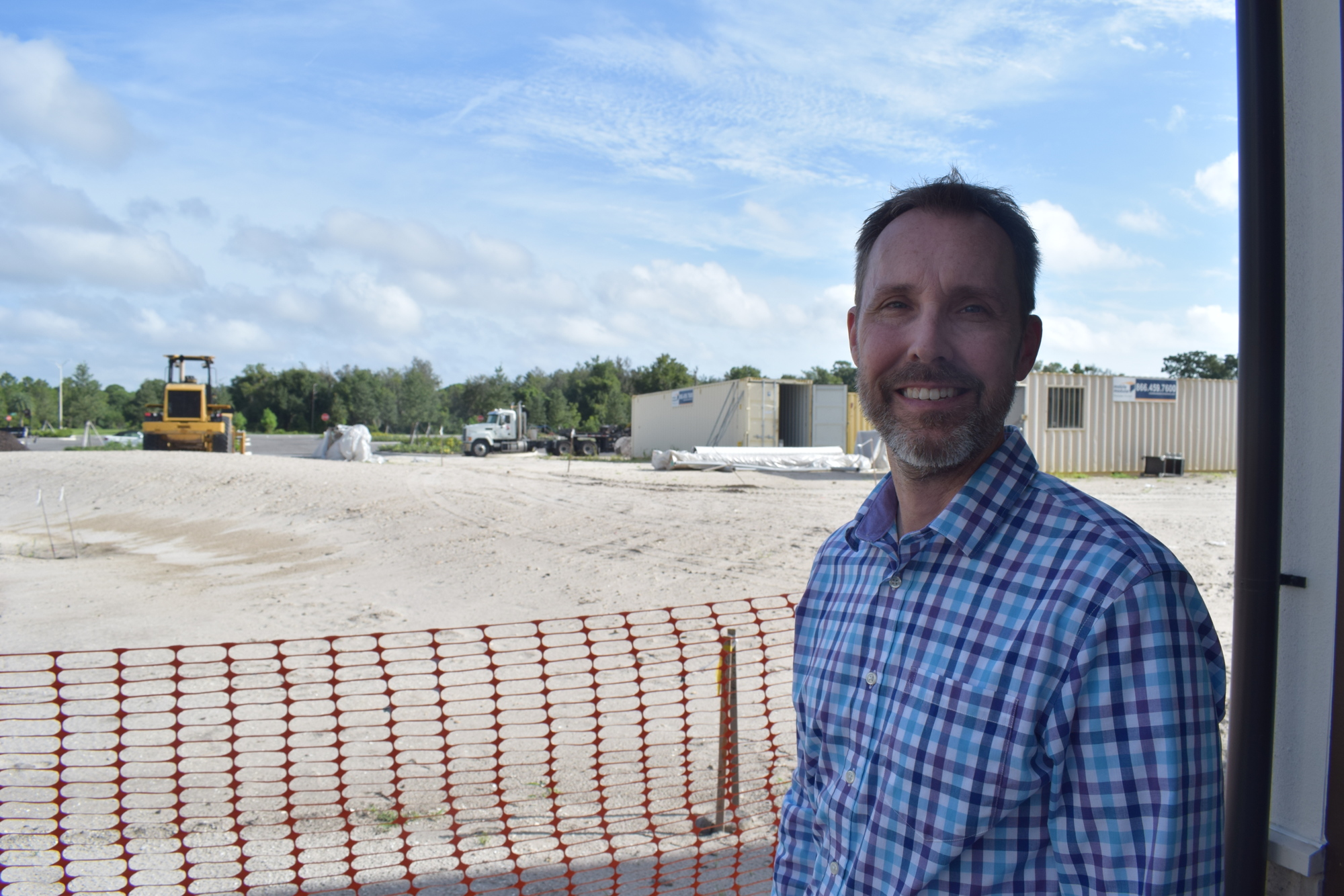 CEO William Skaggs stands next to the empty lot that has been reserved for The Players at Waterside Place. (File photo)