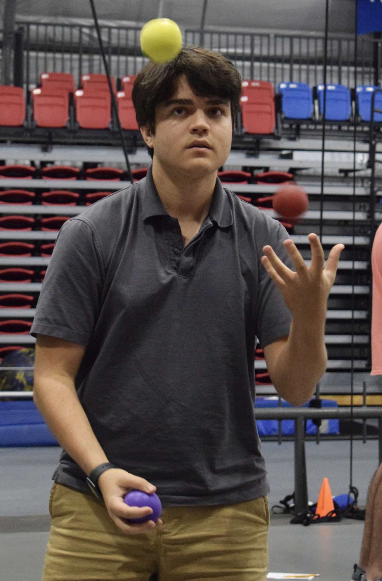 Junior Thomas Vicente works on juggling three balls.