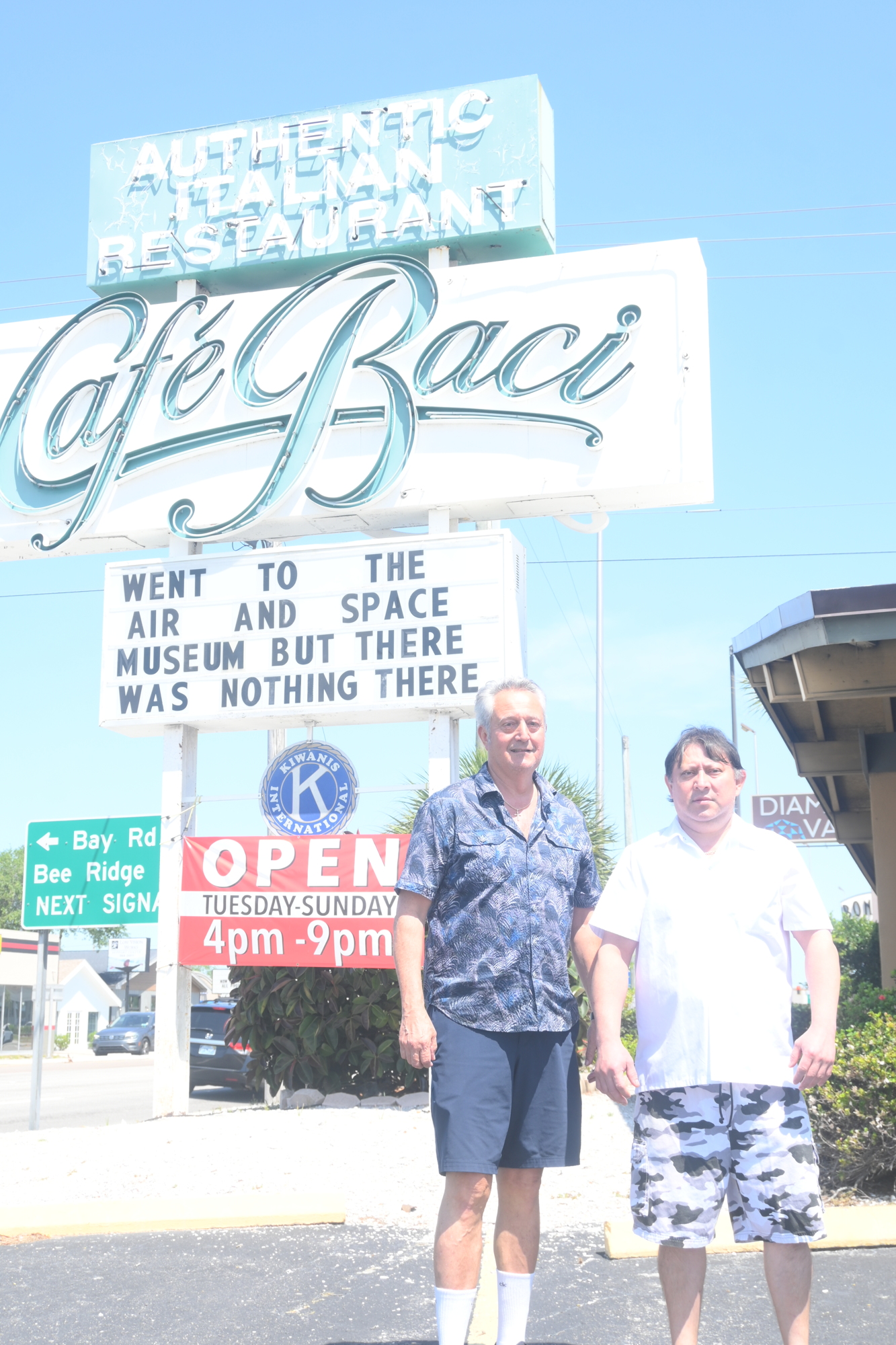 Roberto Mei and chef Eldis Rodriguez stand in front of Cafe Baci's trademark marquee. The restaurant will close its doors in May. (Photo: Spencer Fordin)
