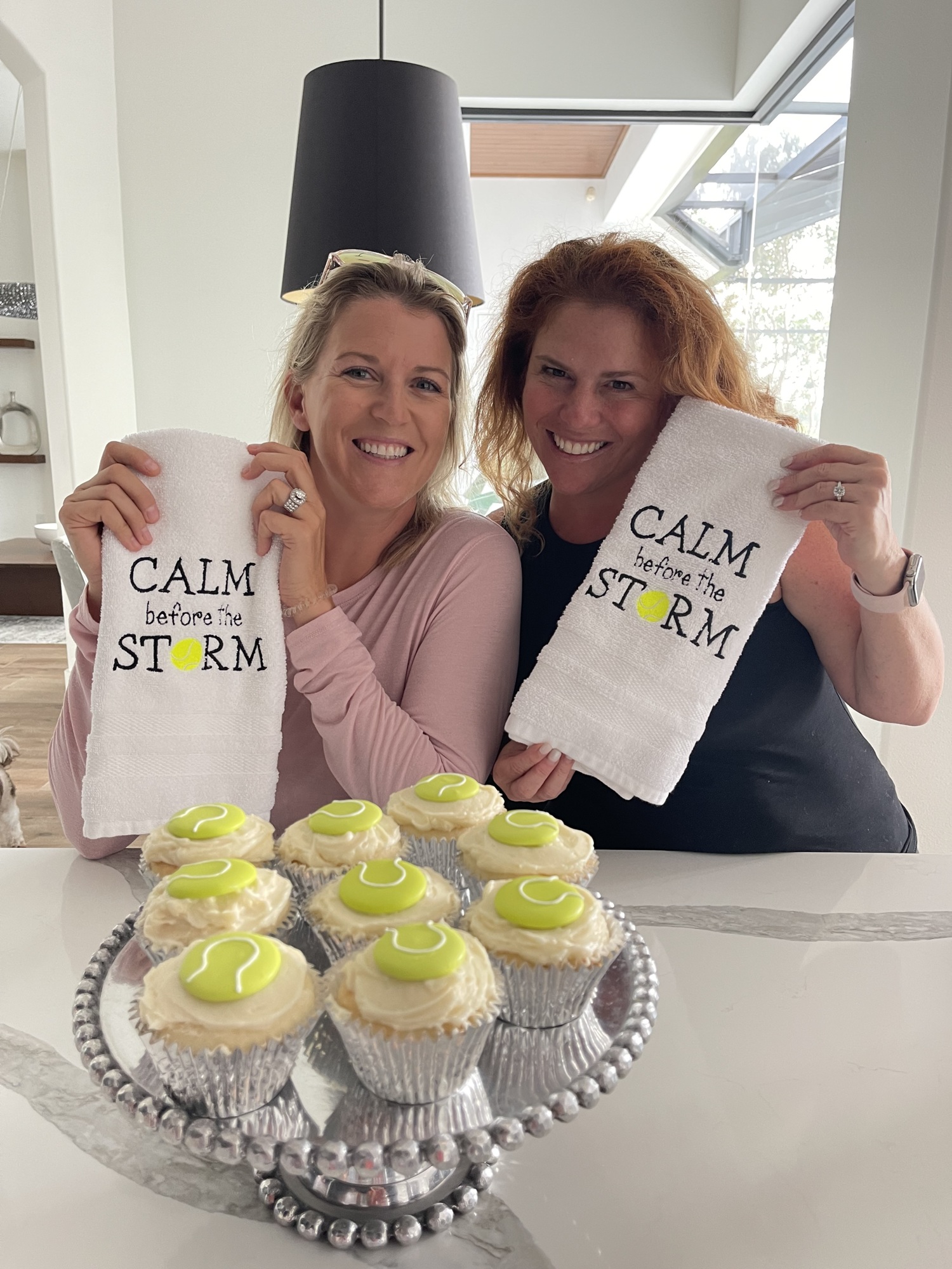 Lauren Larkin and Lauren Navas show off the custom towels and cupcakes that the Lakewood Ranch community made for them in support of their doubles title quest. Courtesy photo.