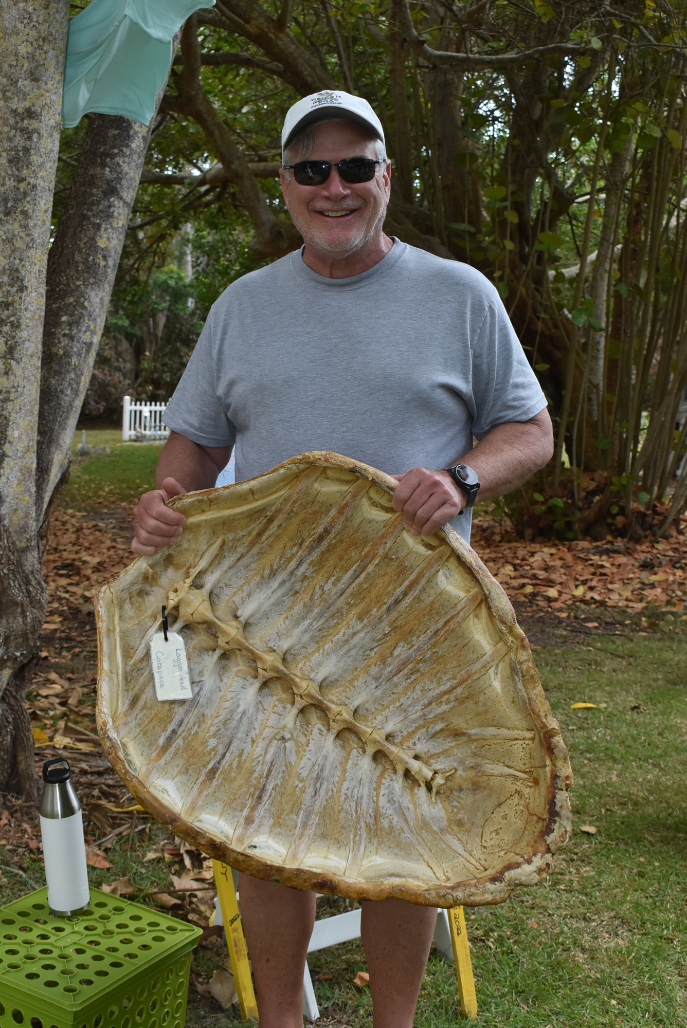Mike Scanlon hoists a turtle shell at the LBKTW table.