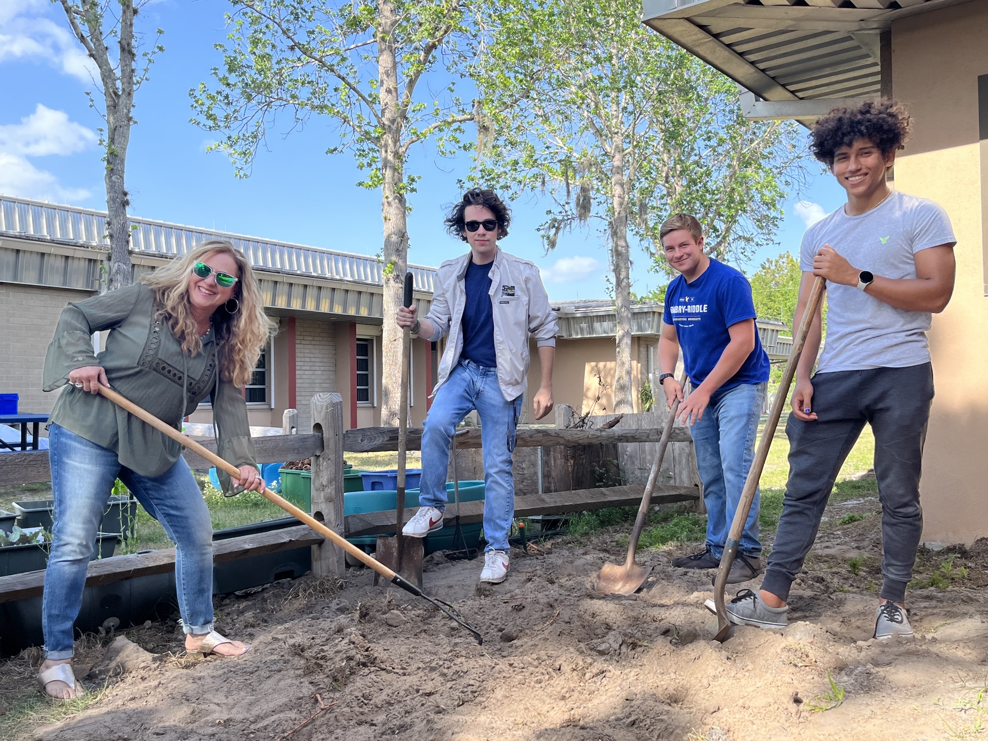 Audrey Quale, a retired Braden River Elementary School teacher, helps high school seniors and her former students Conor Reilly, Jacob Jackson and Zechariah Johnston try to find the time capsule they buried together in fifth grade.