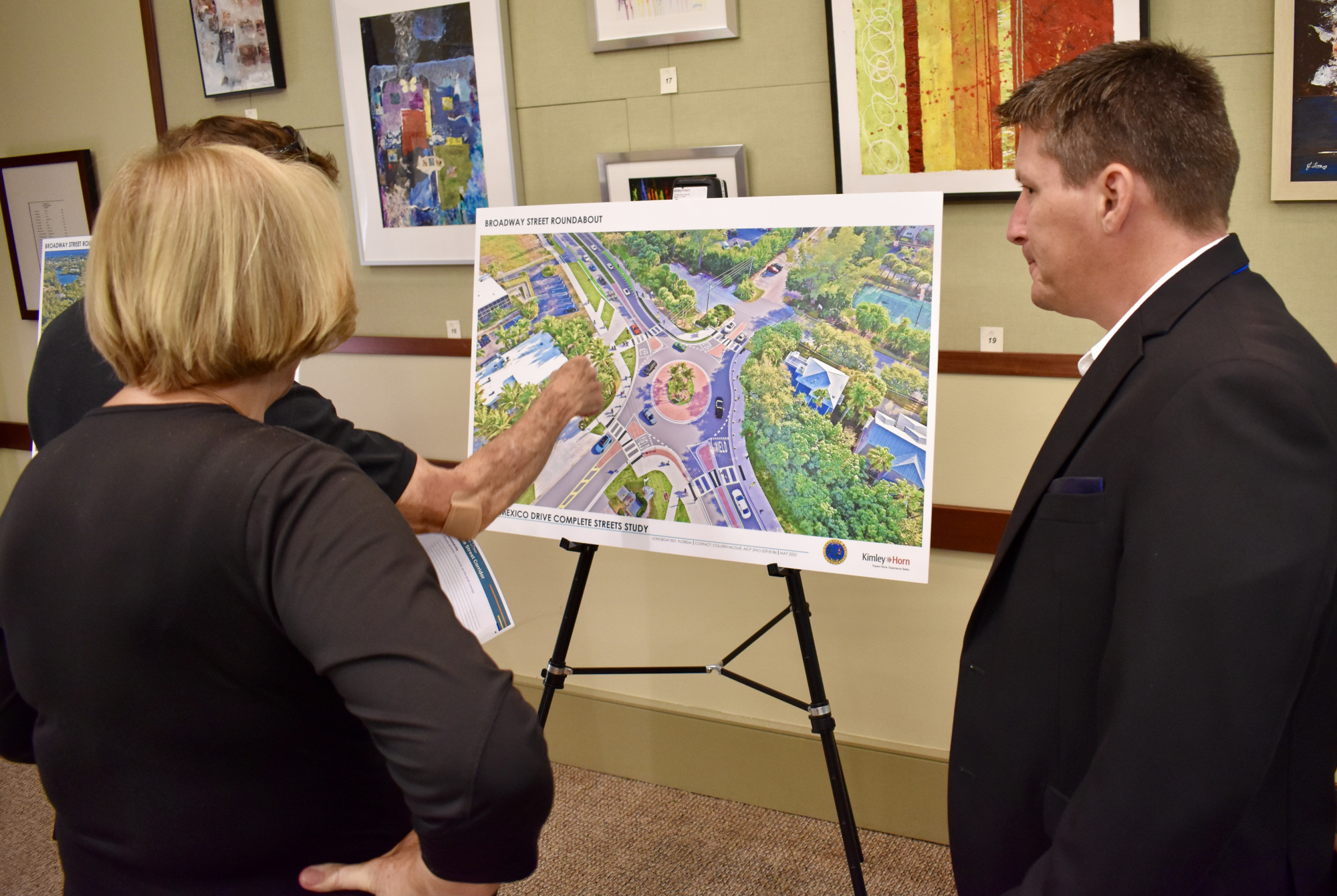 David Bishop, Town Commissioner BJ Bishop look at a proposal for a roundabout on the north end of the island at Broadway Street with Kimley-Horn's Mike Donahue.