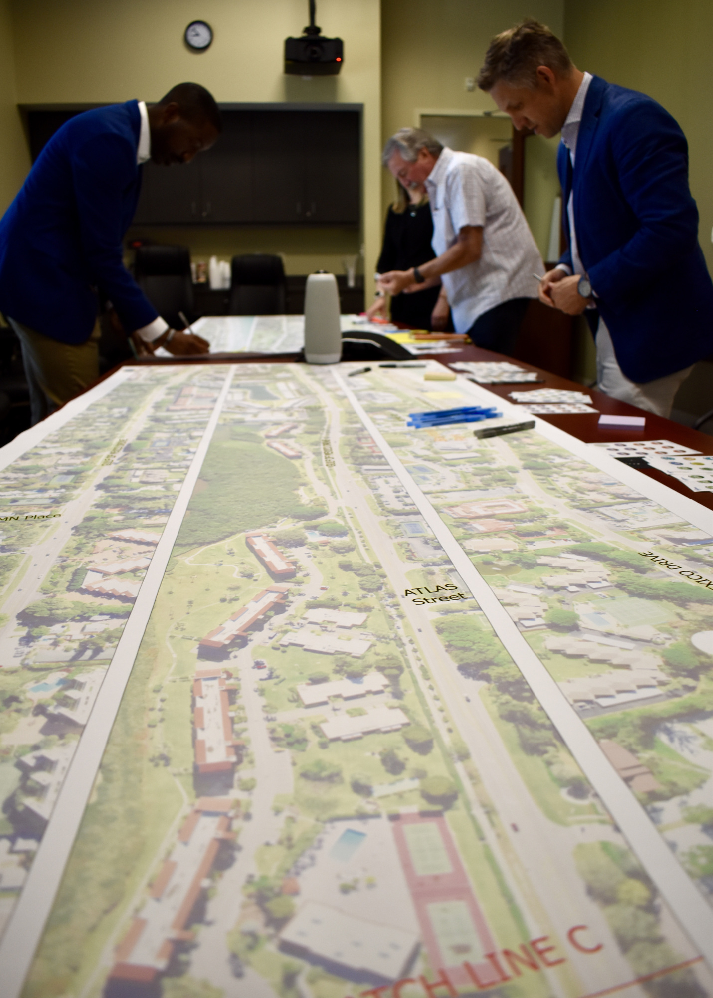 A large-scale map was arrayed across a conference table and another table.