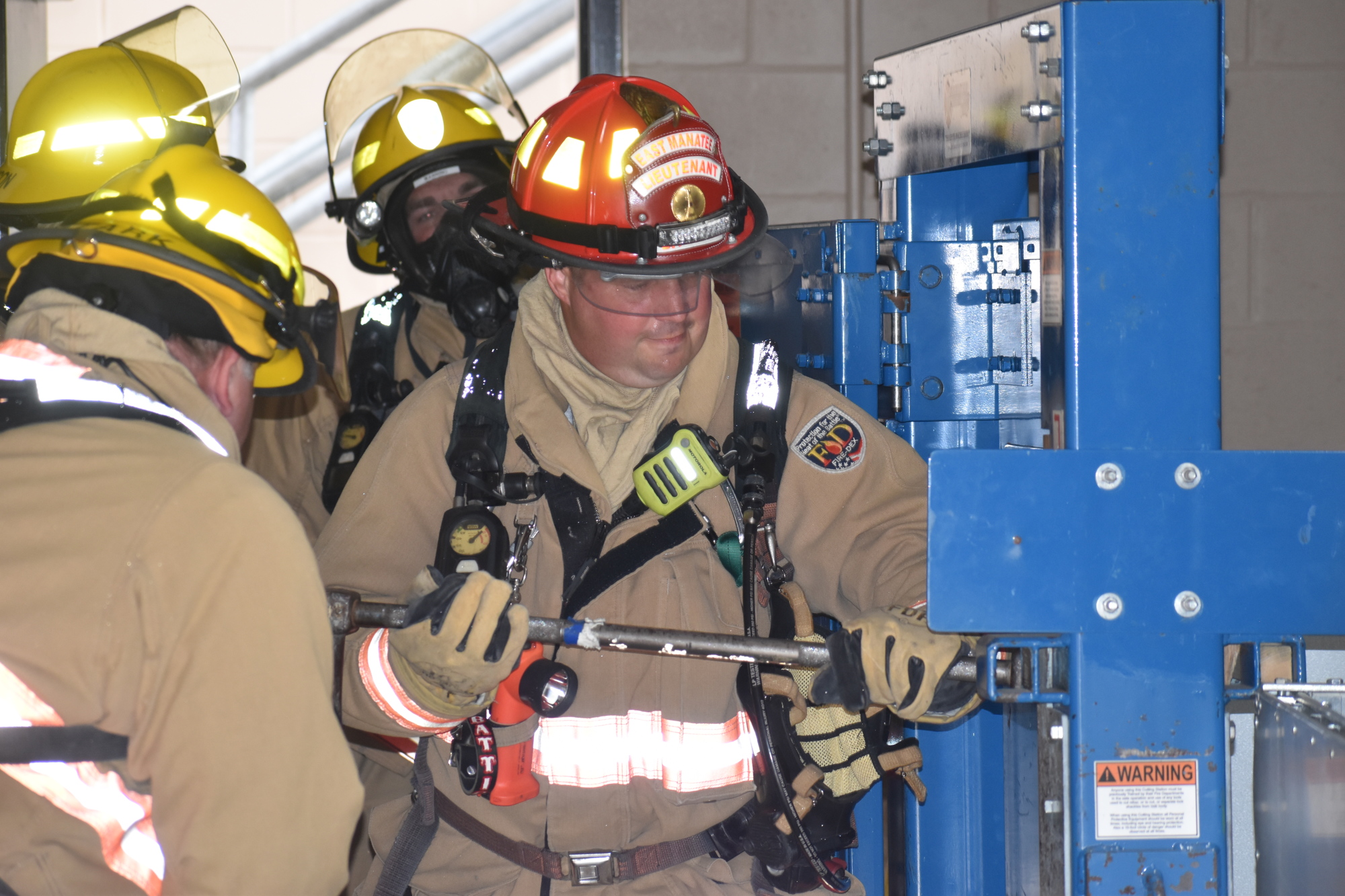 During a training exercise, Lt. Shawn Battick pounds his way through a bolted door.