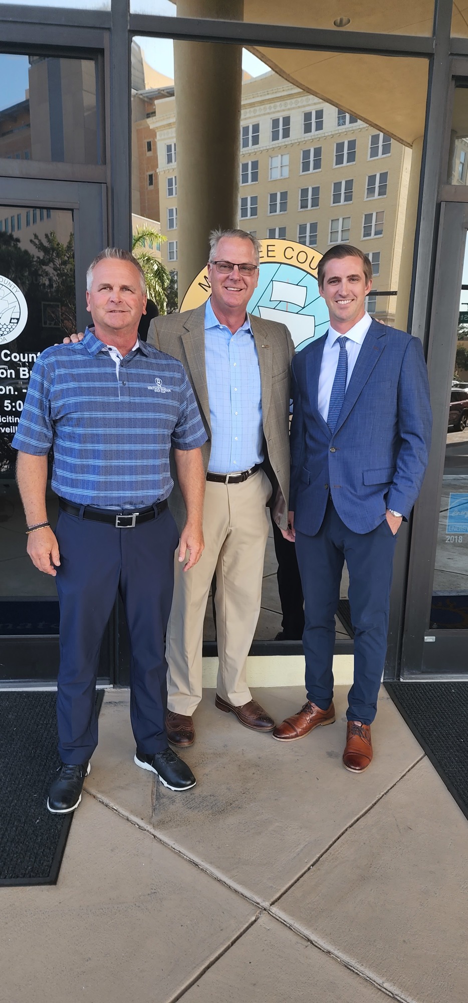 Heritage Harbour's Rick Nelson and Mark Bruce, and their attorney Kyle Grimes, are all smiles after their Heritage Harbour Golf Resort plan was approved by the Manatee County Commission.