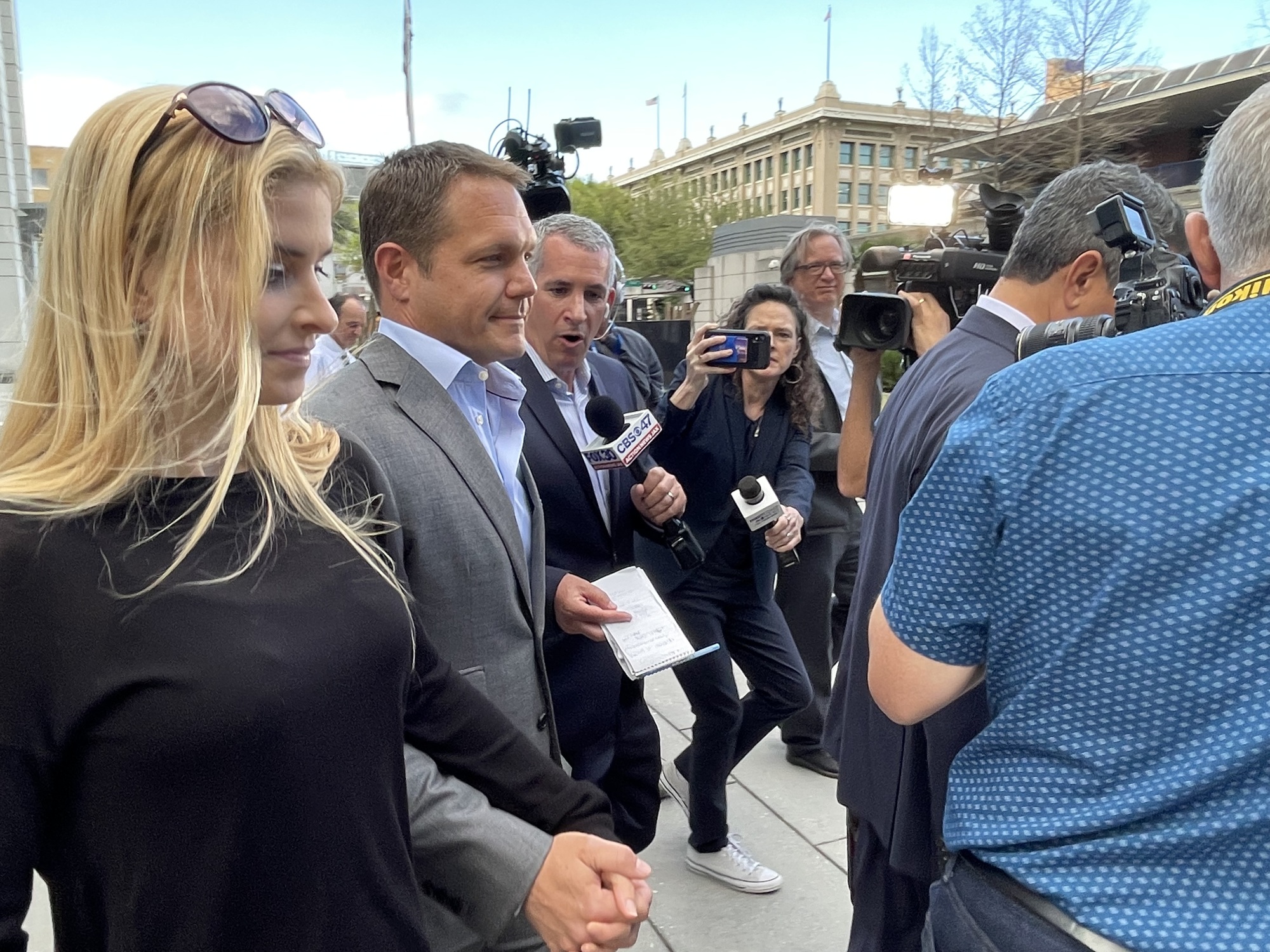 Indicted former JEA CEO Aaron Zahn, center, walks out of the Bryan Simpson U.S. Courthouse Downtown on March 8 with his wife after he pleaded not guilty to federal charges.