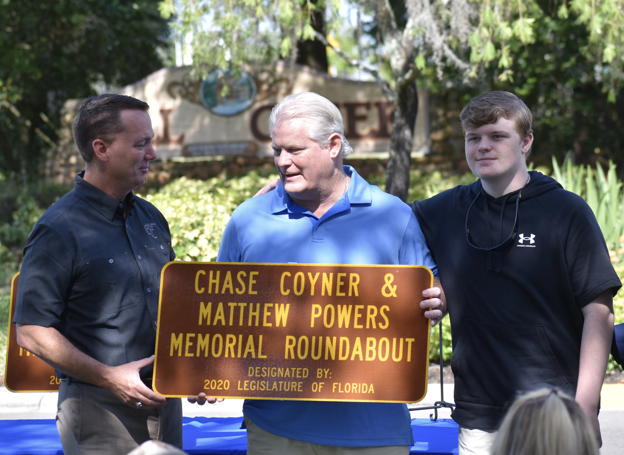 Rep. Tommy Gregory presents Scott Coyner and Cory Coyner with a plaque to honor Chase Coyner and Matthew Powers.