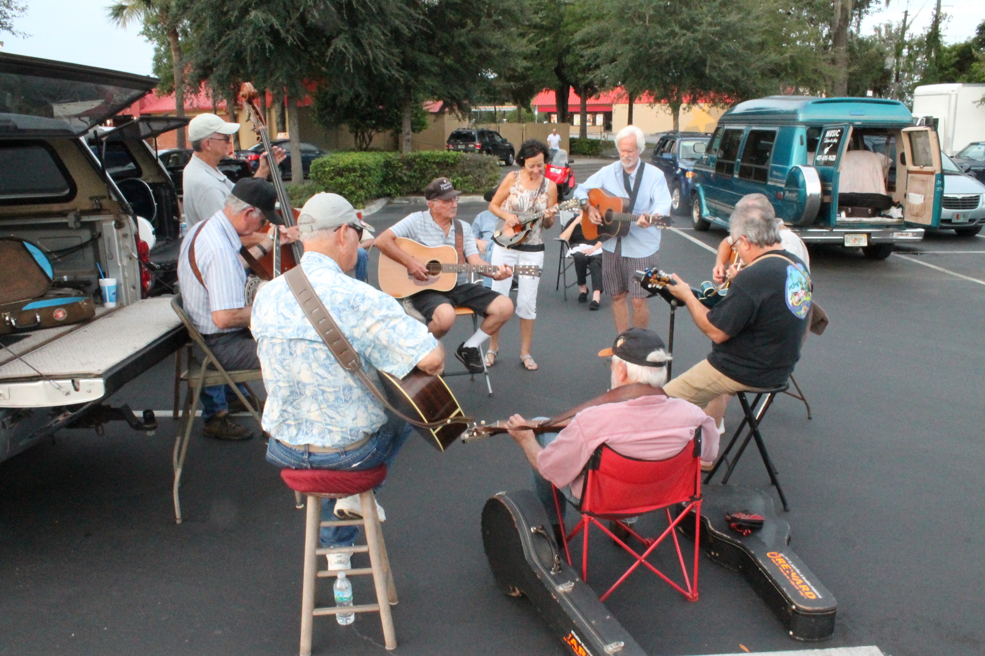 The pickers circle up for their weekly jam in an Ocoee parking lot.