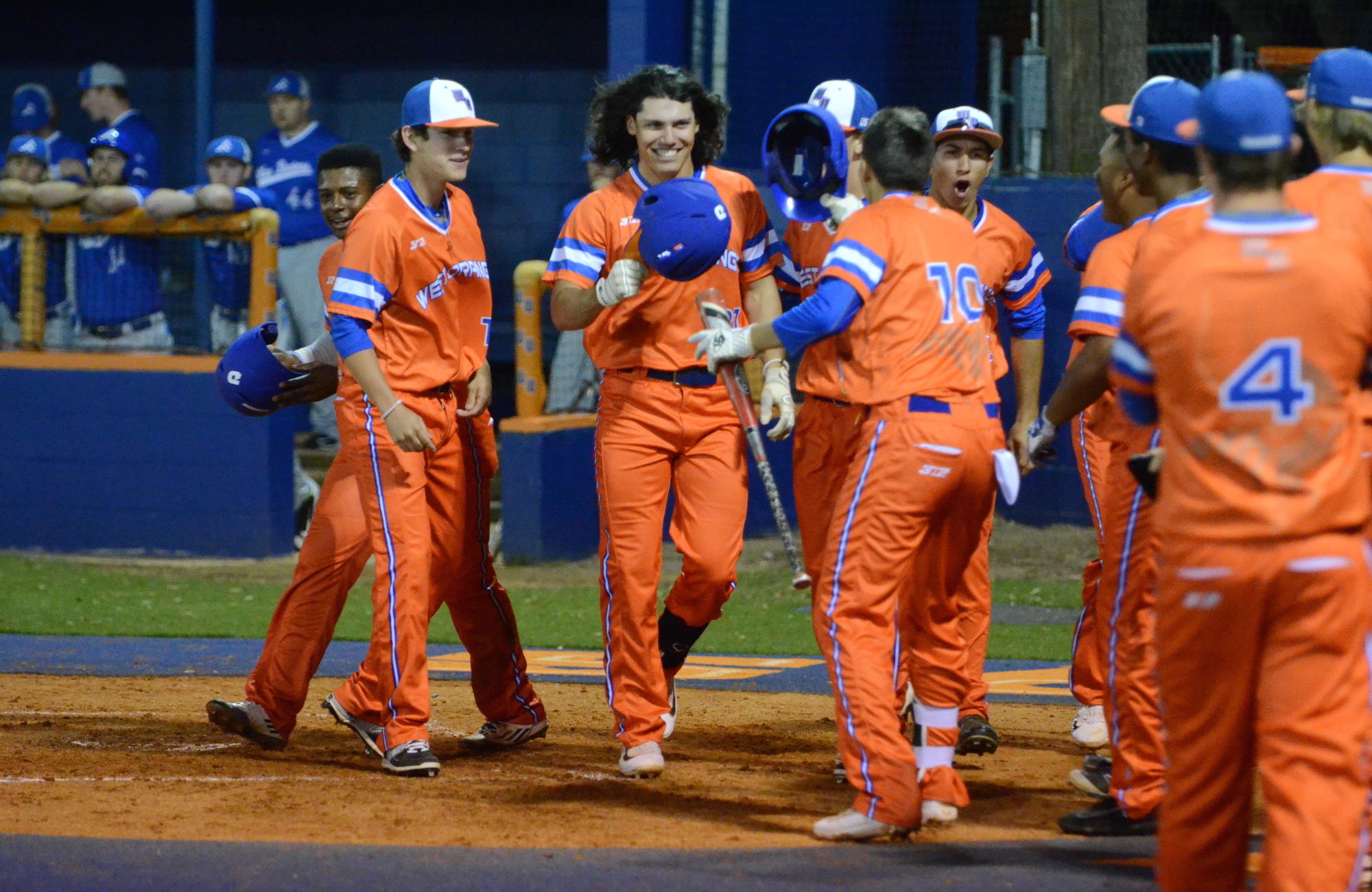 Senior Roberto Guillen is congratulated by teammates after clubbing a home run for the Warriors against Apopka.