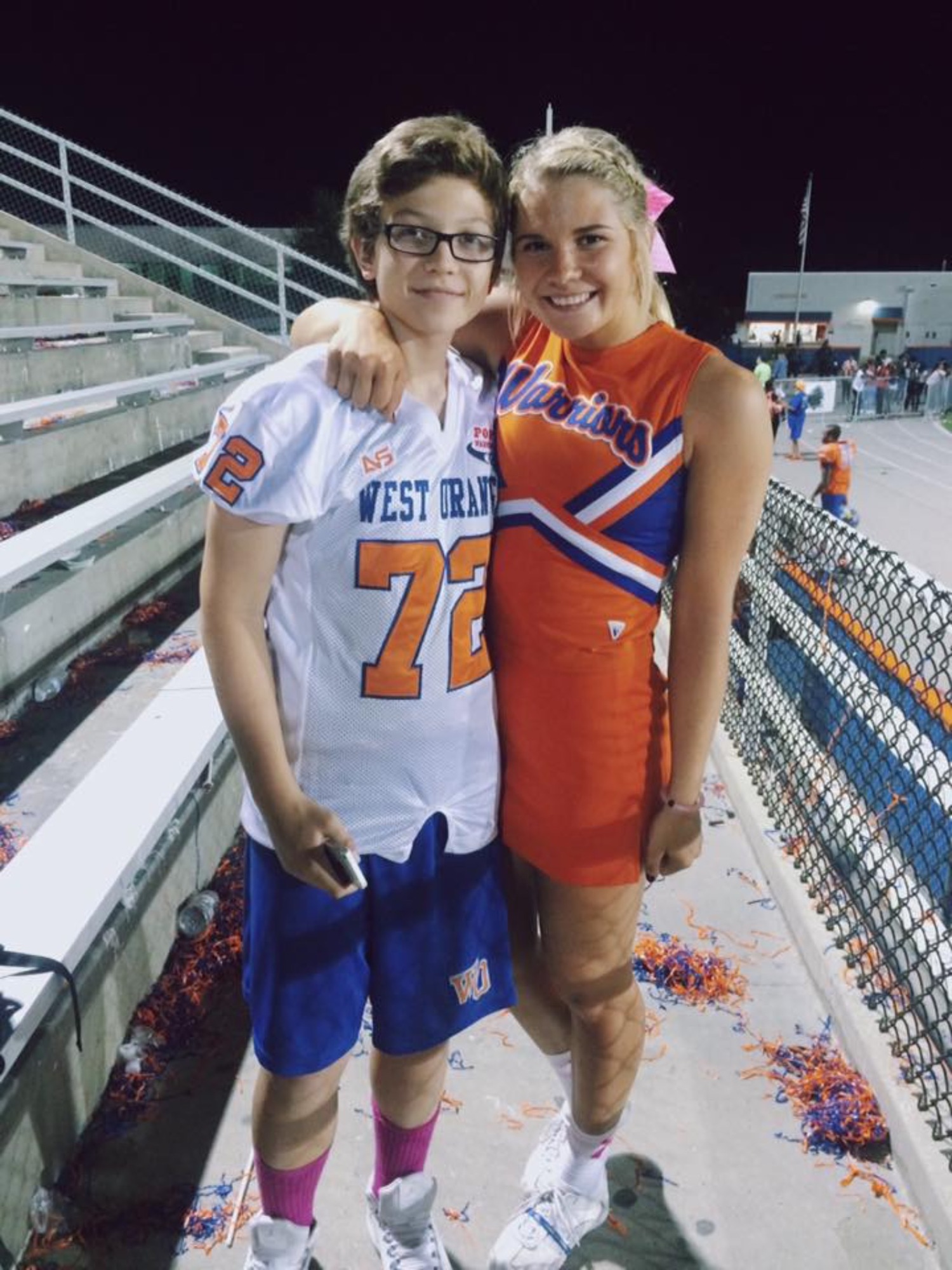 Brandon Paulikas and his sister, Alyssa, share a moment at the West Orange High stadium before his diagnosis.