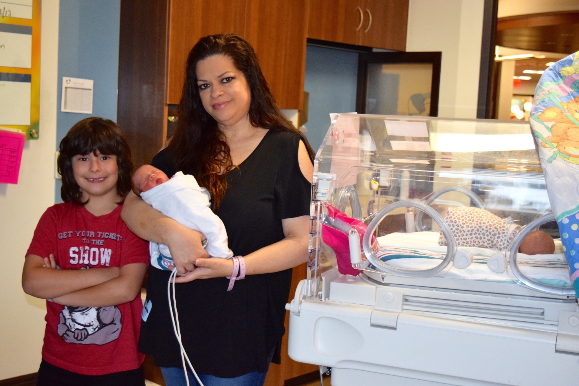After a long hospital stay, Diana Platon — with youngest son, Jax, and twin daughters, Jeena and Jianna — delivered her twins at 32 weeks.