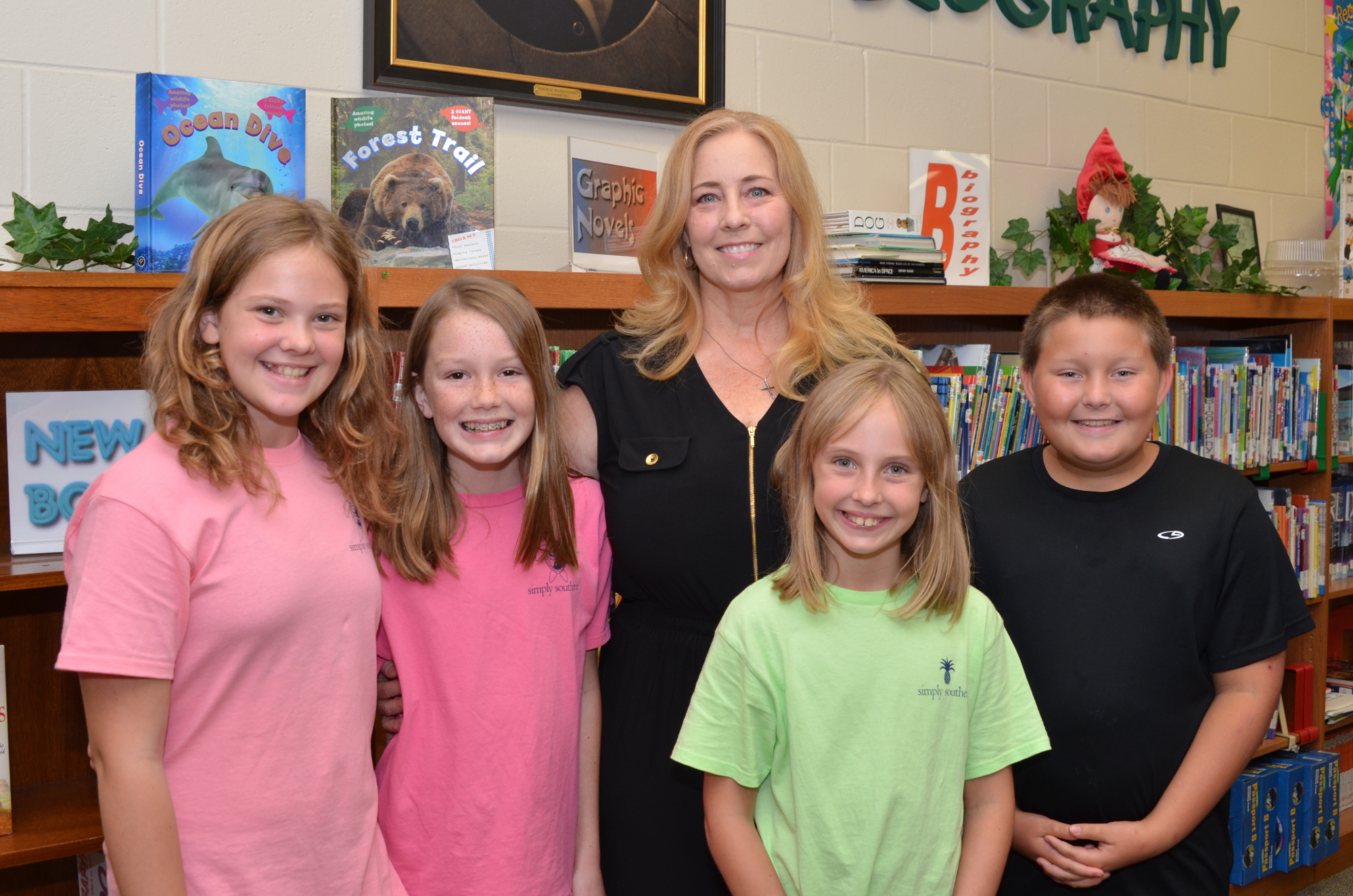 Former students wished Kimmie Laird a happy retirement after 24 years at Dillard Street Elementary: Olivia Sumal, left, Hanna Armstrong, Julia Sumal and Justin Evans.