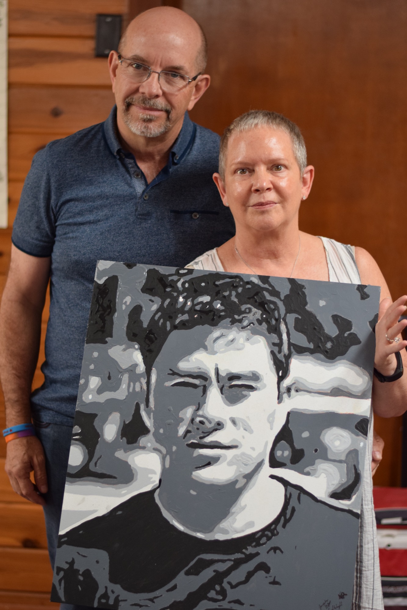 Jerry Wright’s parents, Maria and Fred, hold up their son’s completed portrait.