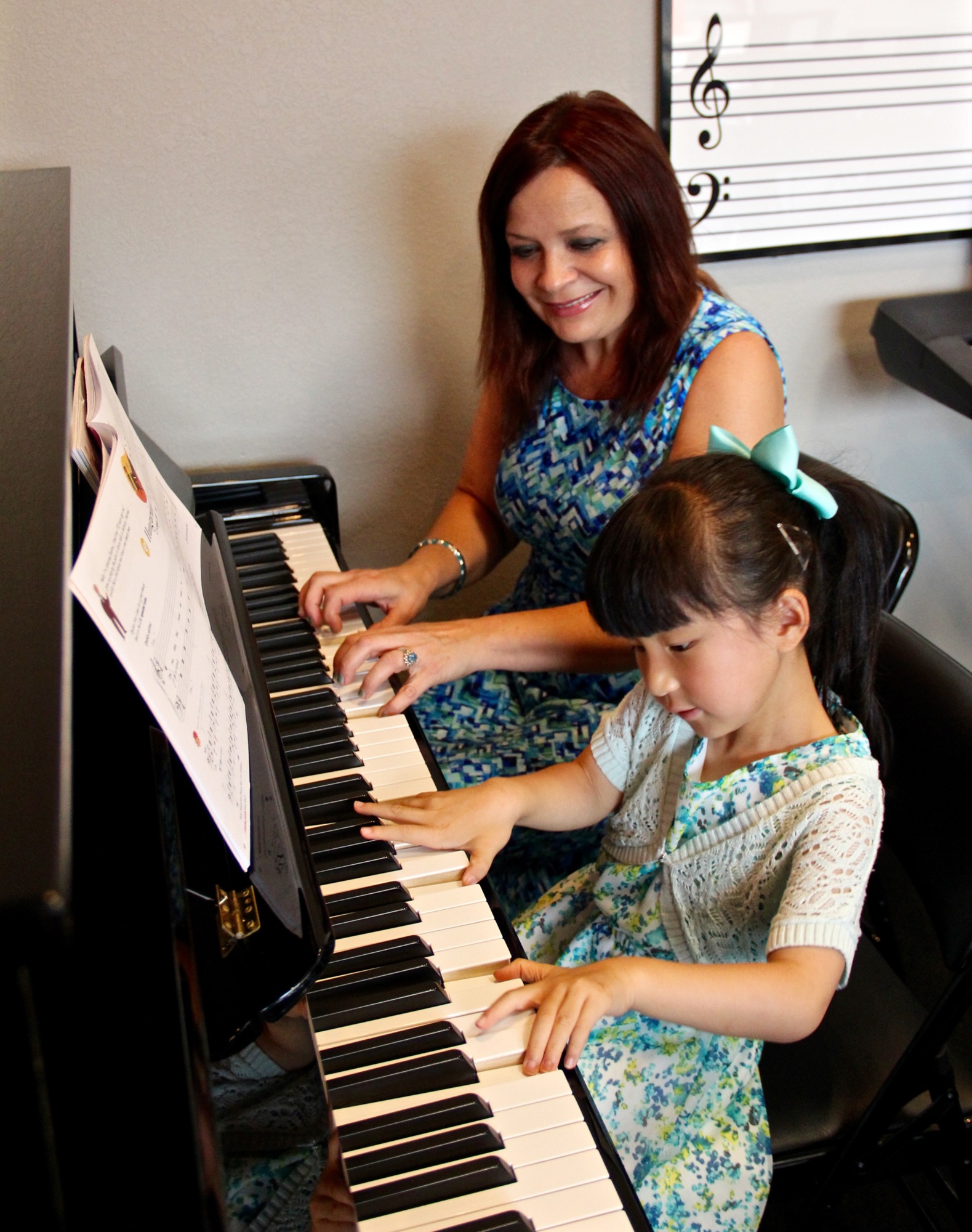 Abigail Huang and her piano teacher play a duet together during her weekly piano lessons.