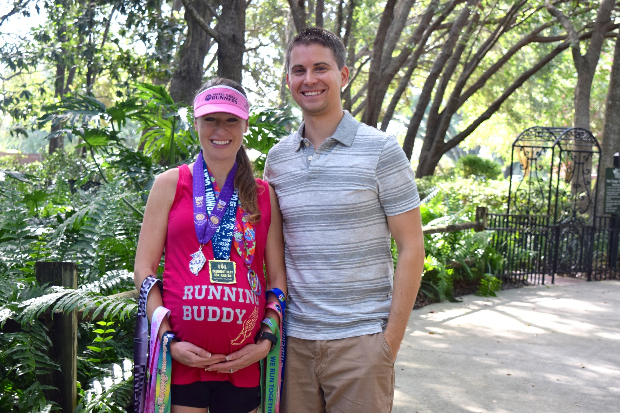 Julie and Steve Yenisch show off Julie and “running buddy” Ryker’s nine medals.
