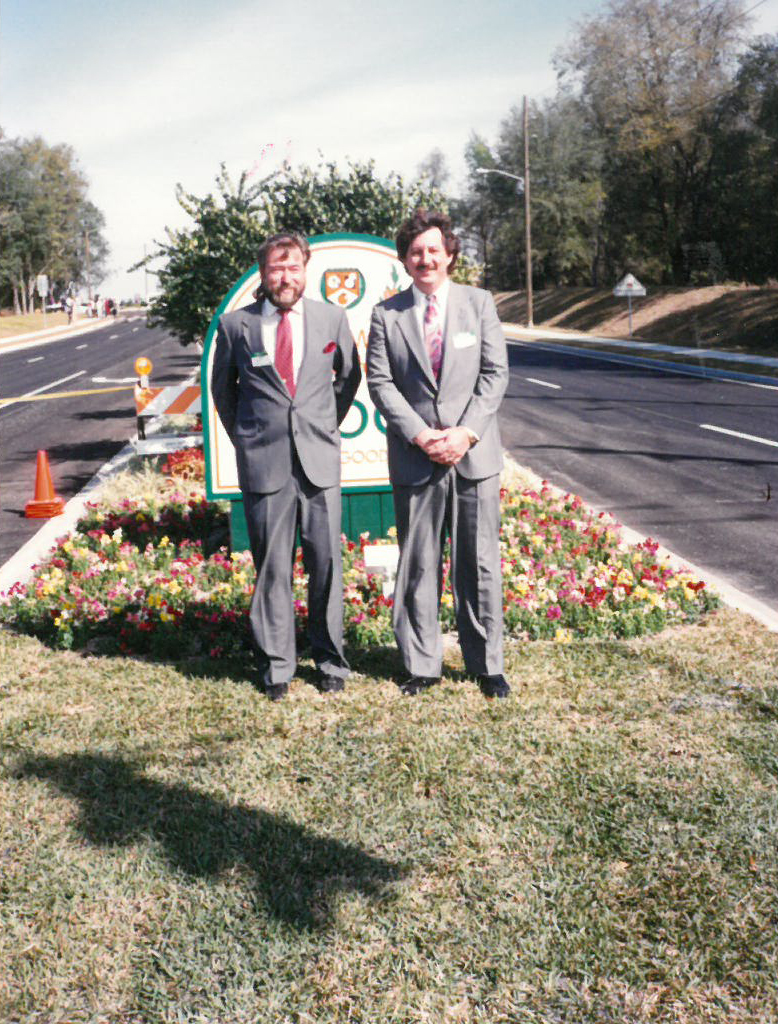 City employees Buddy Elmore, left, and Ray Brenner celebrated the opening of Clarke Road.