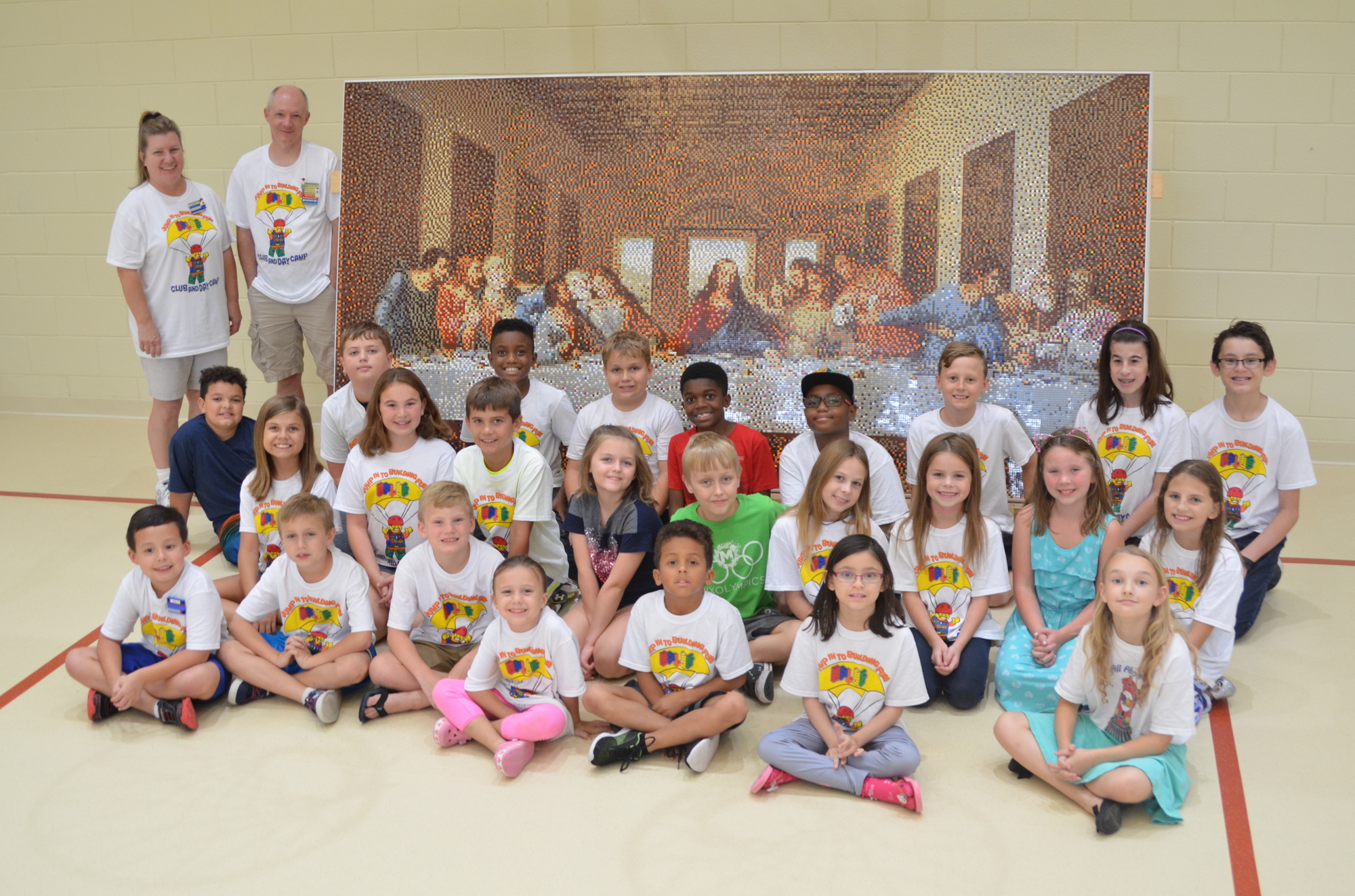 Some of the 73 students who helped build the 78,408-piece LEGO mosaic of 