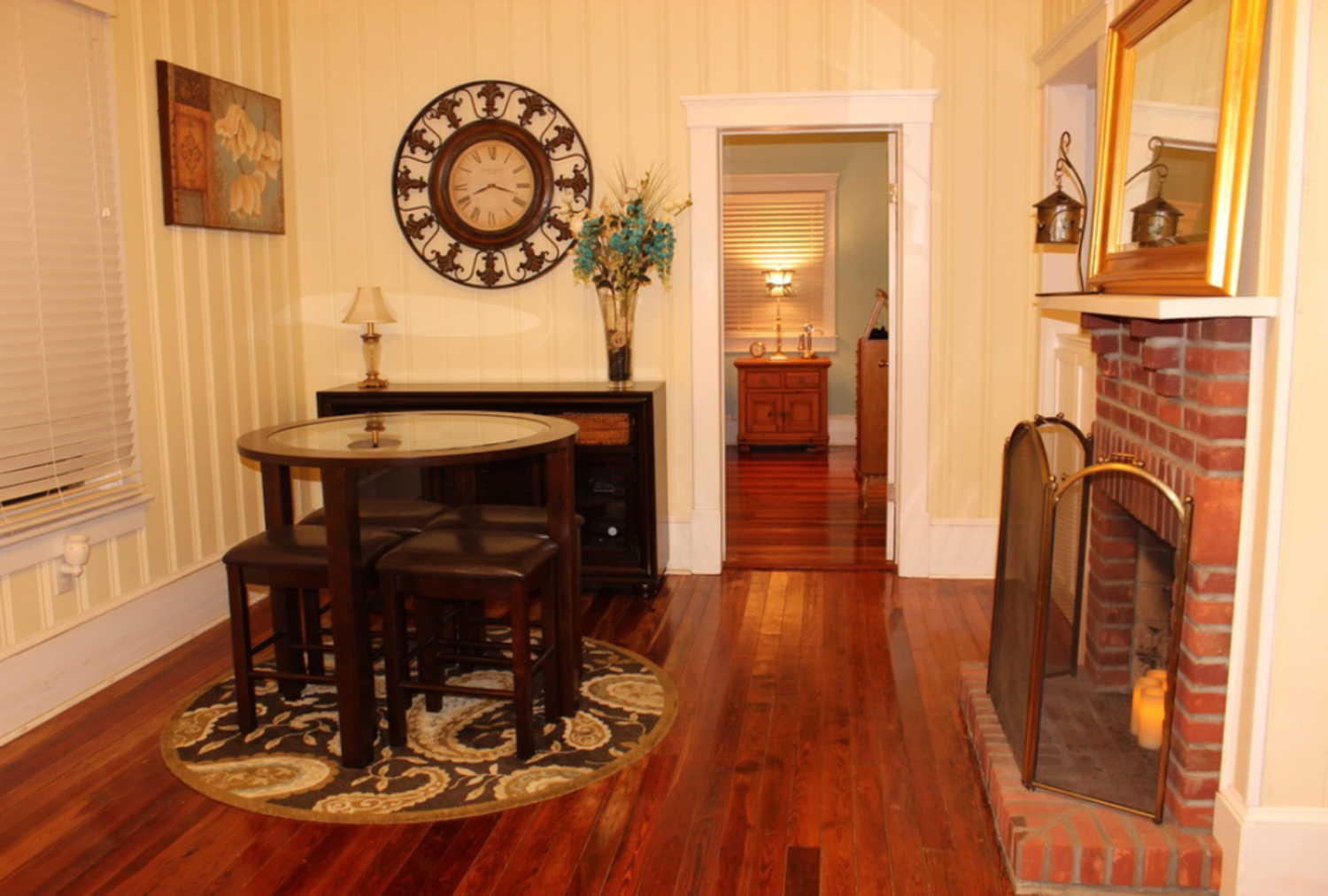 This photo from when the house was listed shows the floors in the front room by the fireplace in excellent condition.