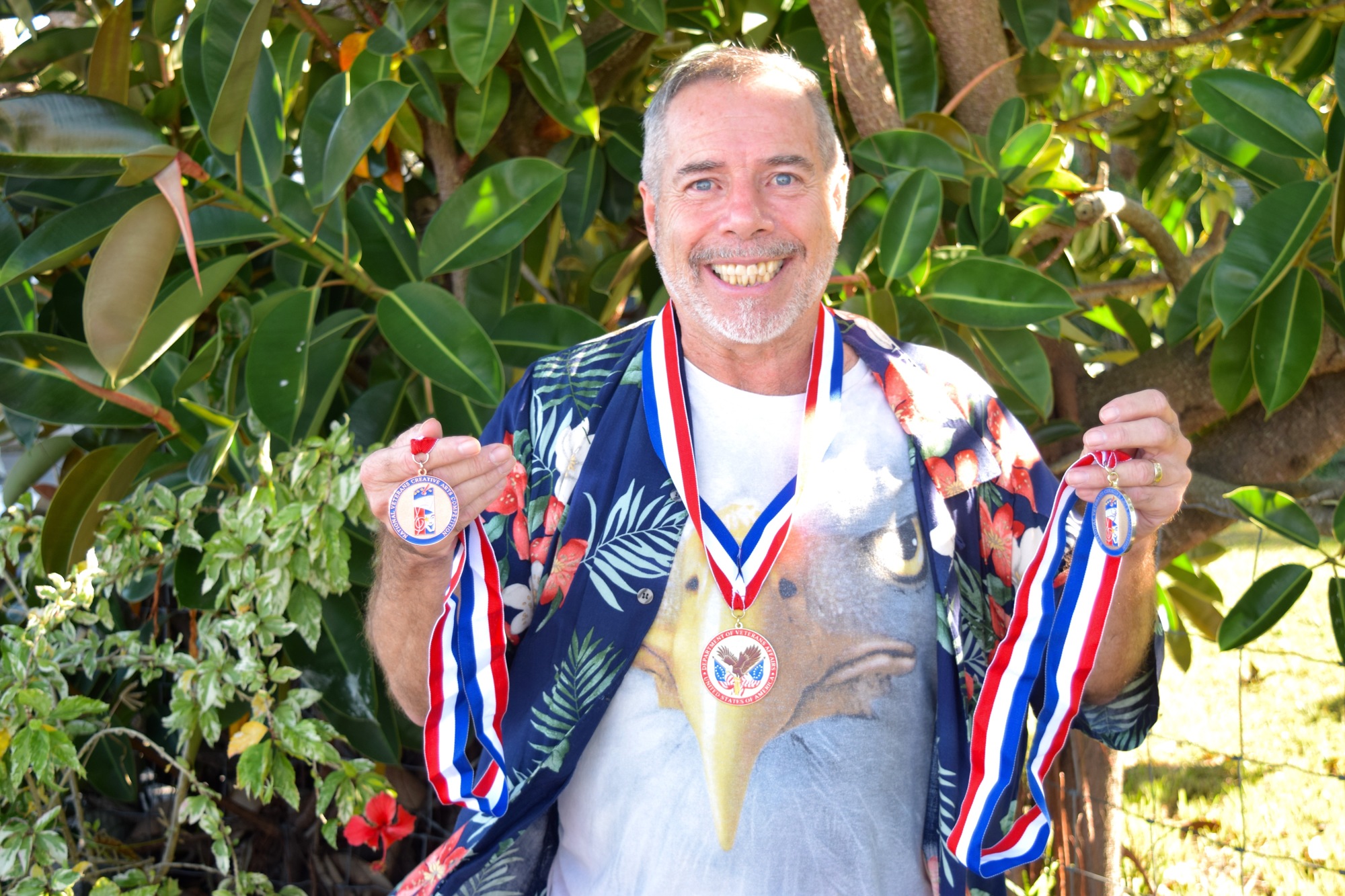 Ernie Windhauser, a U.S. Marine Corps veteran, proudly holds the medals he earned for his drama and flag-dance performances.