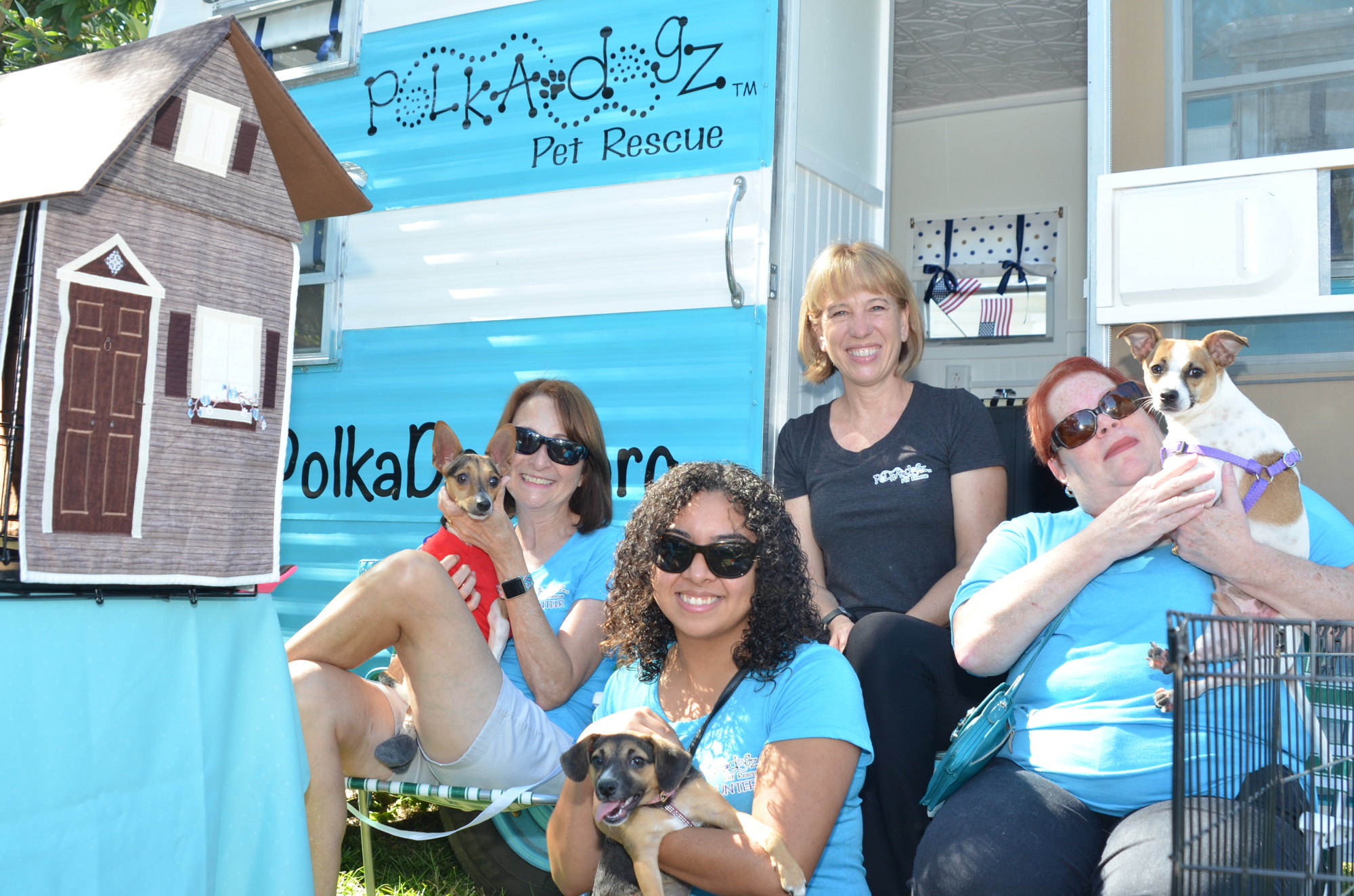 Polka-dogz Pet Rescue brought several of its adoptable pets to the Gracie's anniversary event: Denise Tutas, left, with Goose; Heidi Hardman; Ashley Trigueros with Rosetta; and Ellen Winter with Maverick.