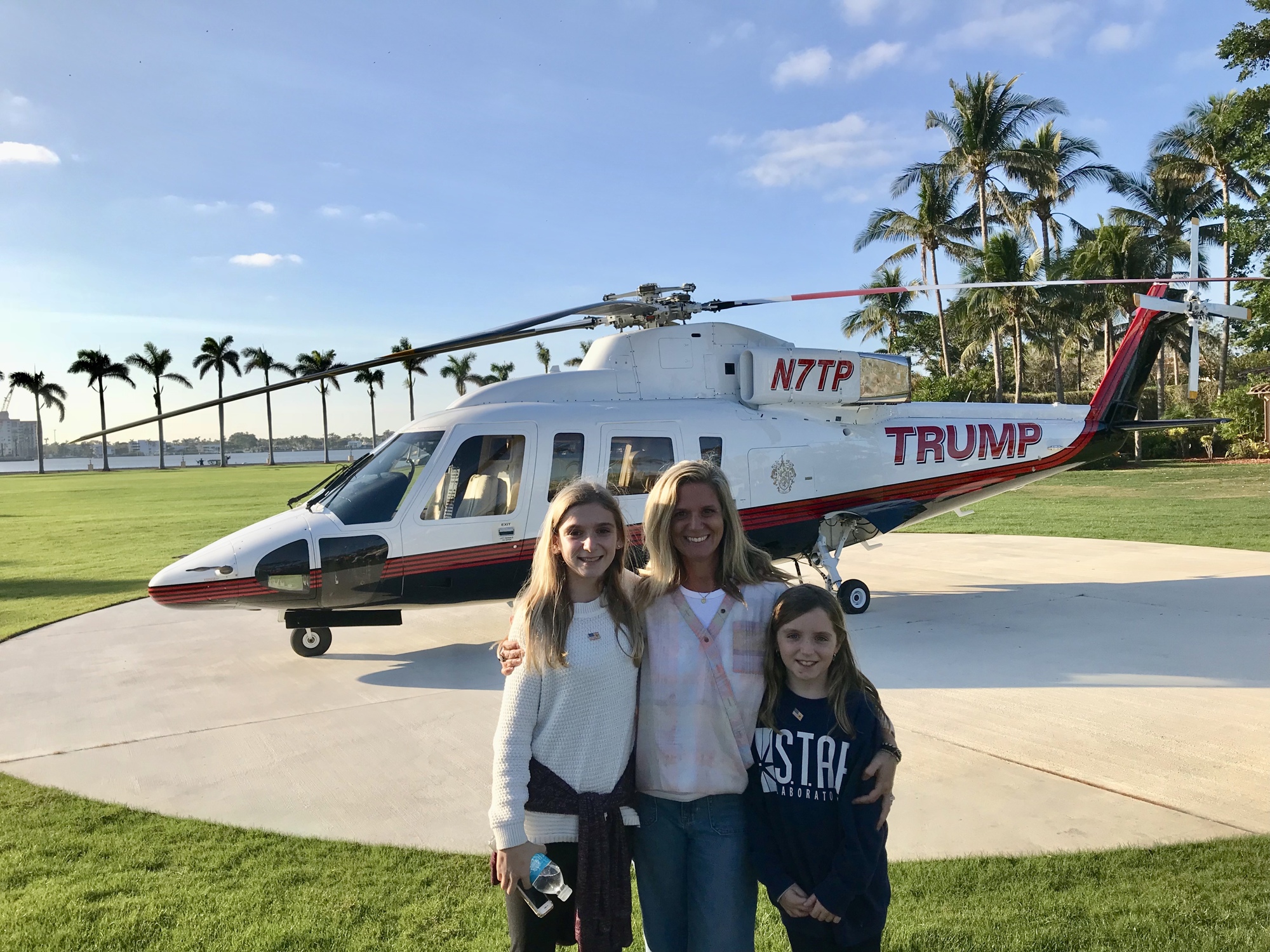 Katie Leccese of Windermere and her daughters, Brooke and Jamie, use Trump's helicopter as a backdrop for their photo.