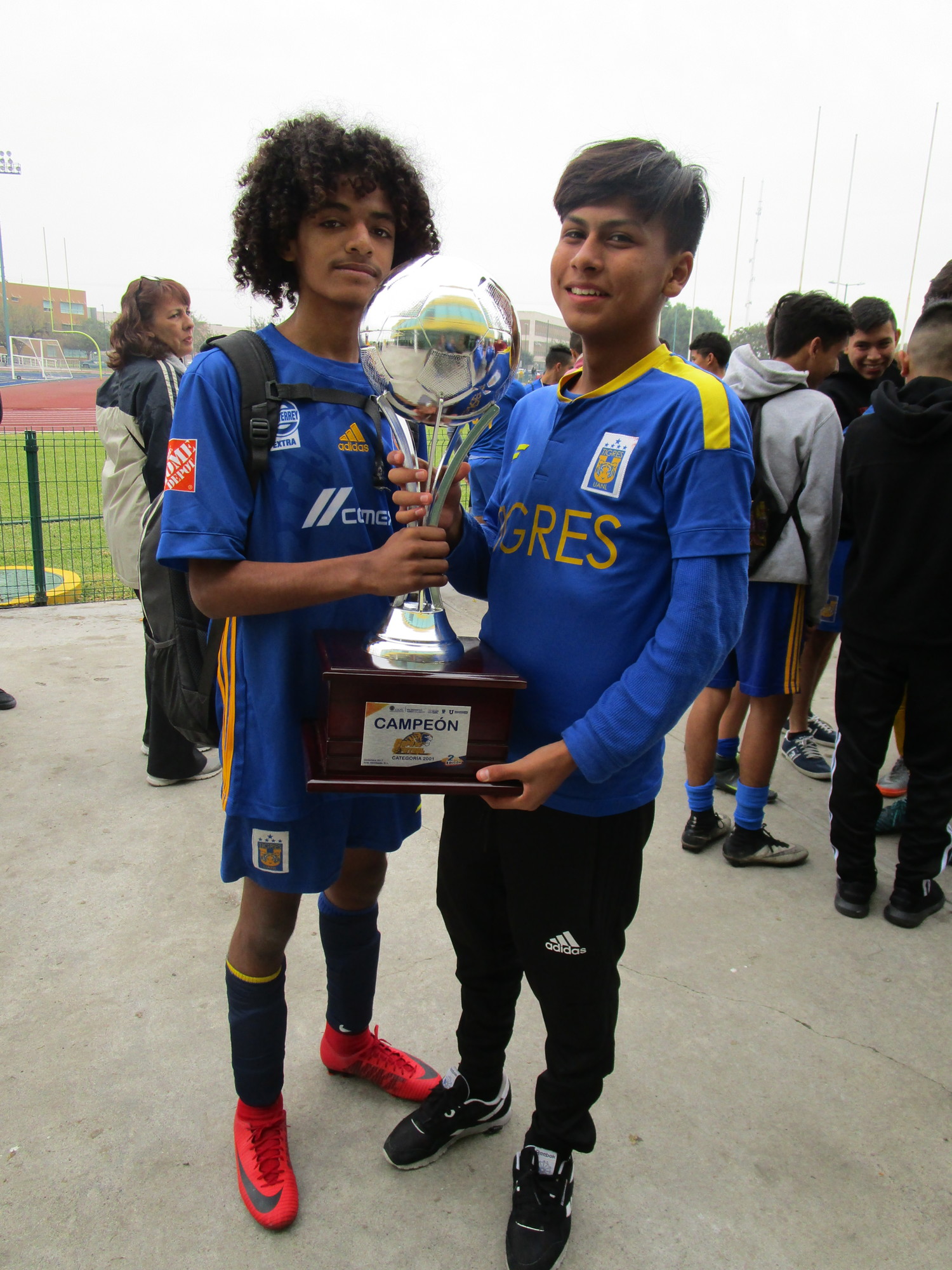 West Orange youths Daniel Rocha and Emerson Nambo show off the trophy they helped the Tigres Orlando team win at a tournament in Monterrey, Mexico.