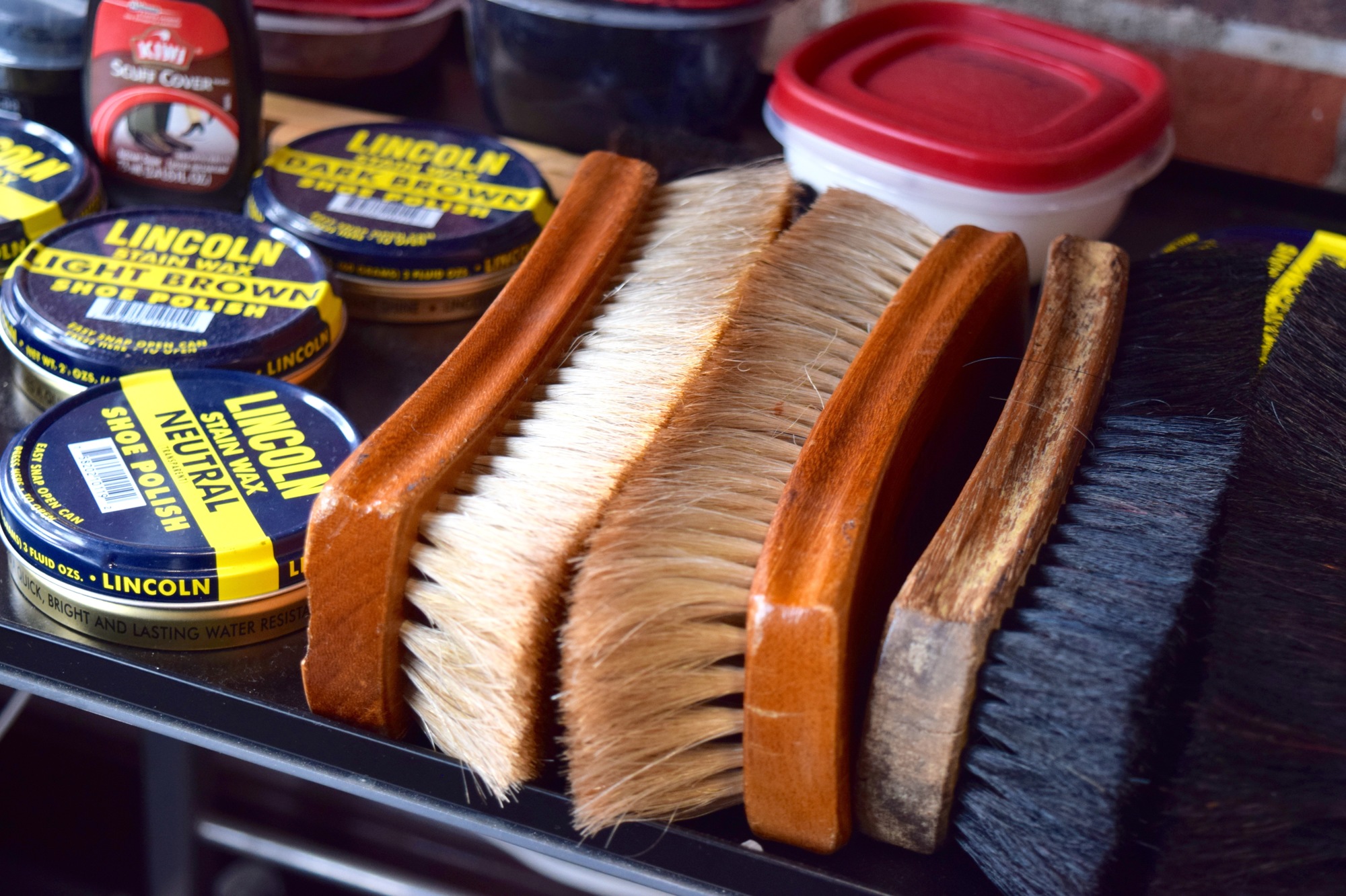 Real horse-hair brushes and various-colored polishes are two of the tools Hector Hidalgo uses in the shoe-shining process.