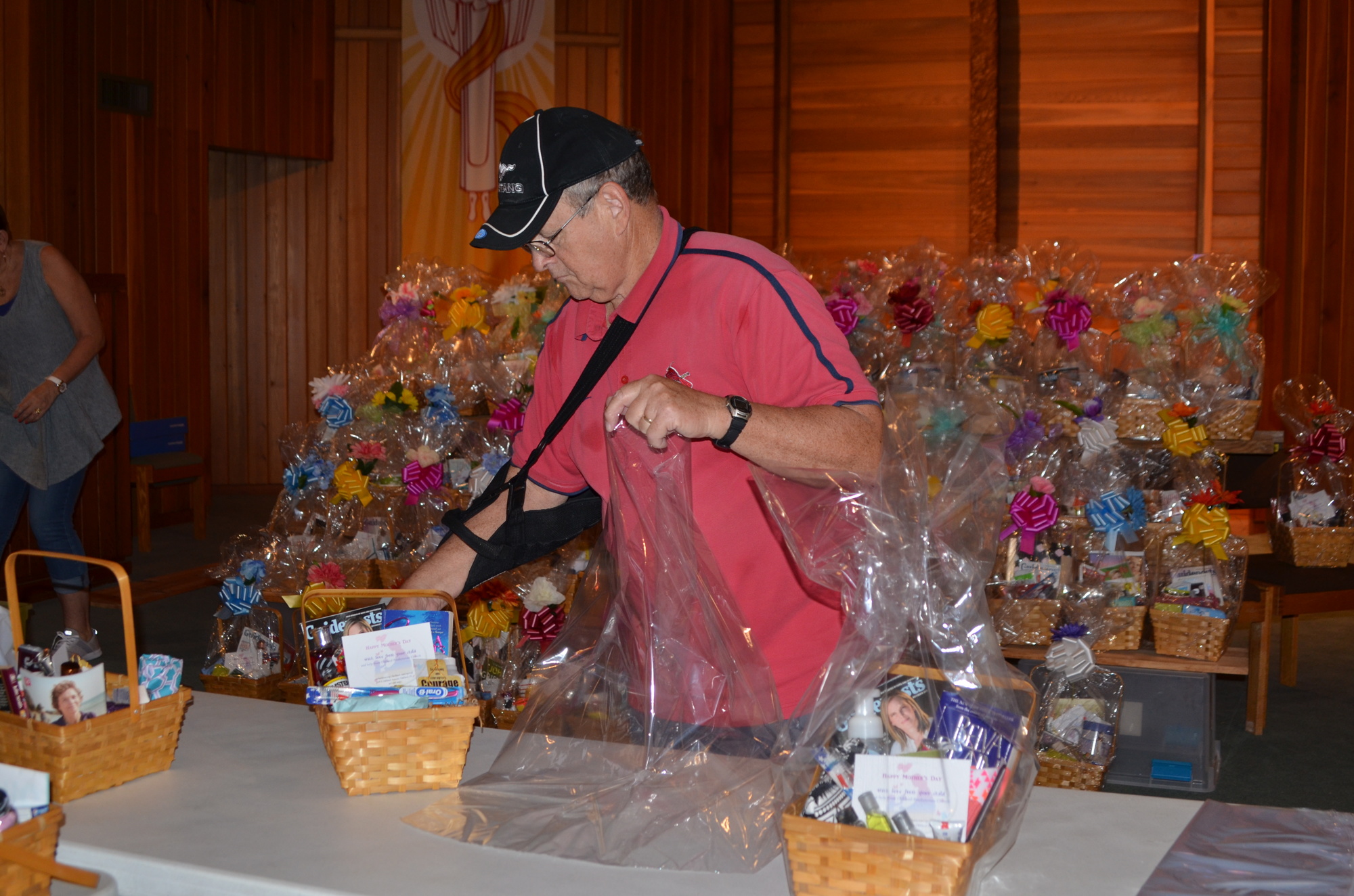 Al Passwater sets the baskets in cellophane for wrapping.