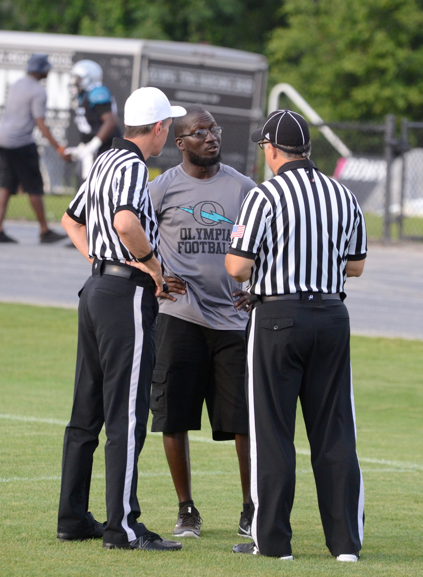 New Olympia coach Travis Gabriel chats with officials before the Titans' spring game May 11.
