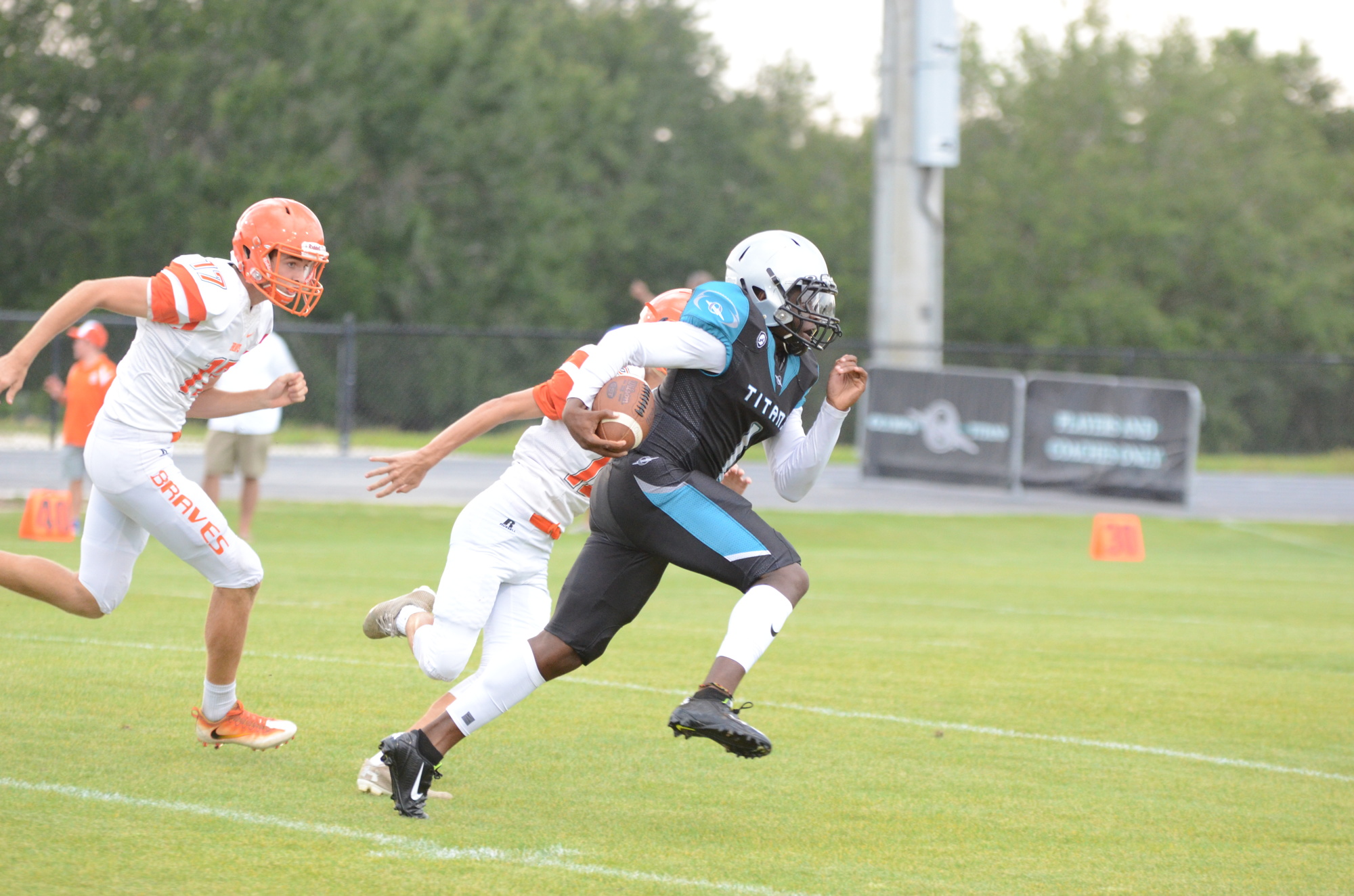 Tealson Jean breaks away for a touchdown for the Titans on the first play from scrimmage May 11.