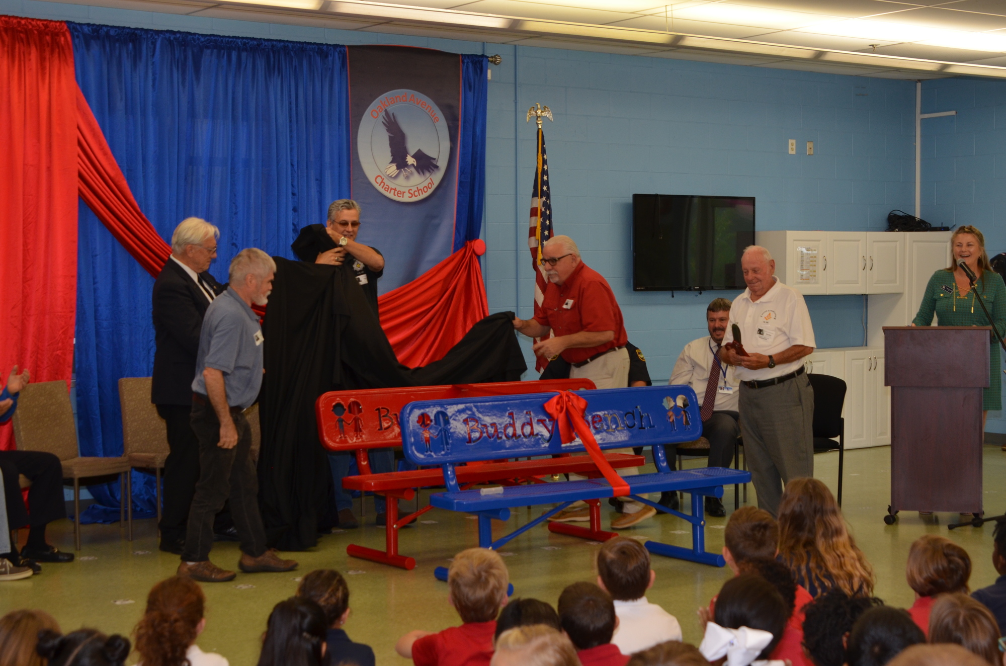 Members of Winter Garden Masonic Lodge No. 165 F&AM unveil the two new Buddy Benches at Oakland Avenue Charter School.