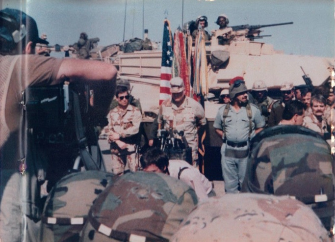 Melvin Henry, of Winter Garden, sits in the tank, top right, on assignment to secure the area near the oil wells when Gen. Norman Schwarzkopf and Iraq President Saddam Hussein (both standing in center) met for a news conference. 