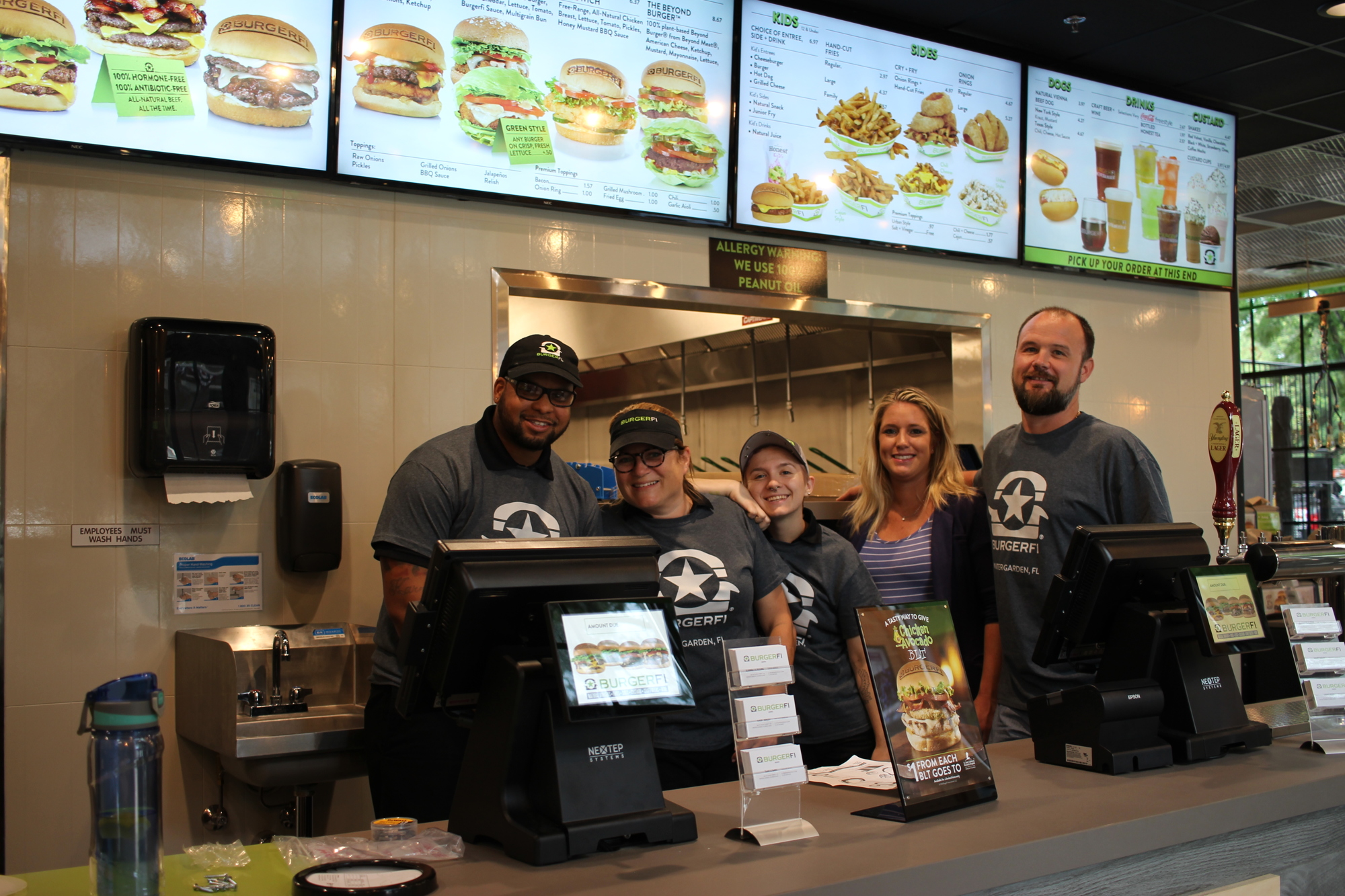 Brett Stevens, left, Jeannette Kleine, Kay Mertens, Kaley Maloy and Eric Koeser are excited for the opening of BurgerFi Winter Garden.