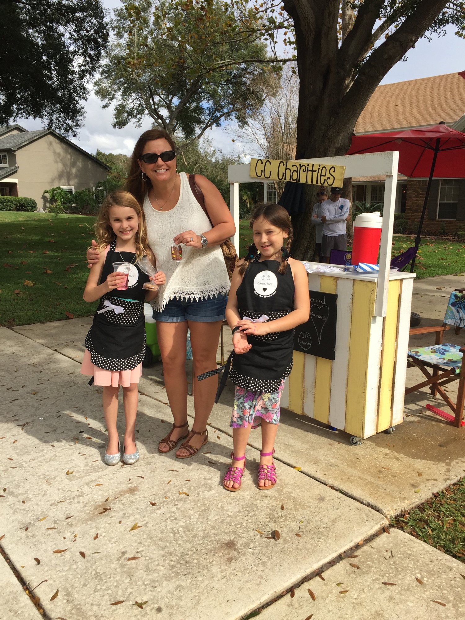 Windermere supporter Lynnette Powell purchases sweets from Claire O’Malley, left, and Carmella Duell.