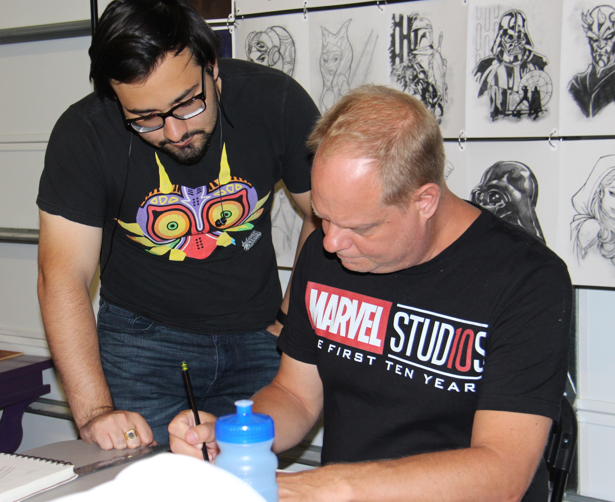 Peter Smith, right, works on a drawing with Nico Perez at the Florida Film Academy, where Smith teaches illustration and character design.