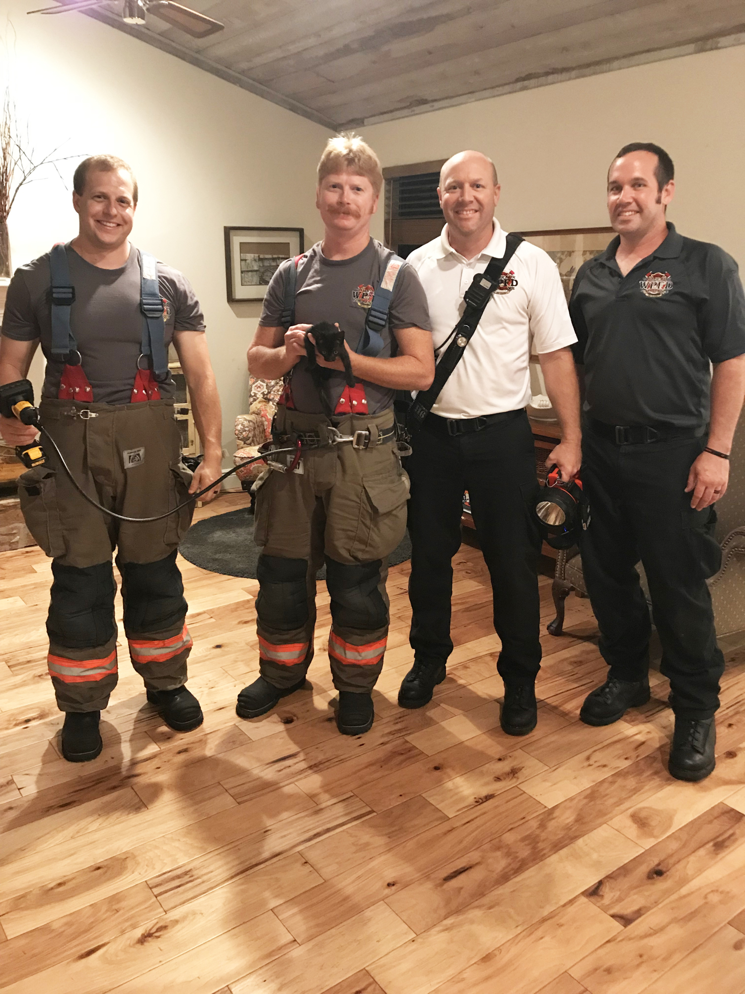 Joe Celletti, Kevin Dixon, Brad Grainger and Kevin Powers of the Winter Park Fire-Rescue Department rescued little Tiller after he got trapped in a vanity on Aug. 9.