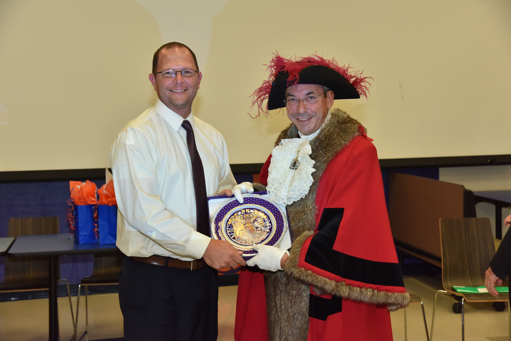 Band director Kenneth Boyd accepts a gift from the British dignitary. Photo by Thomas Lightbody