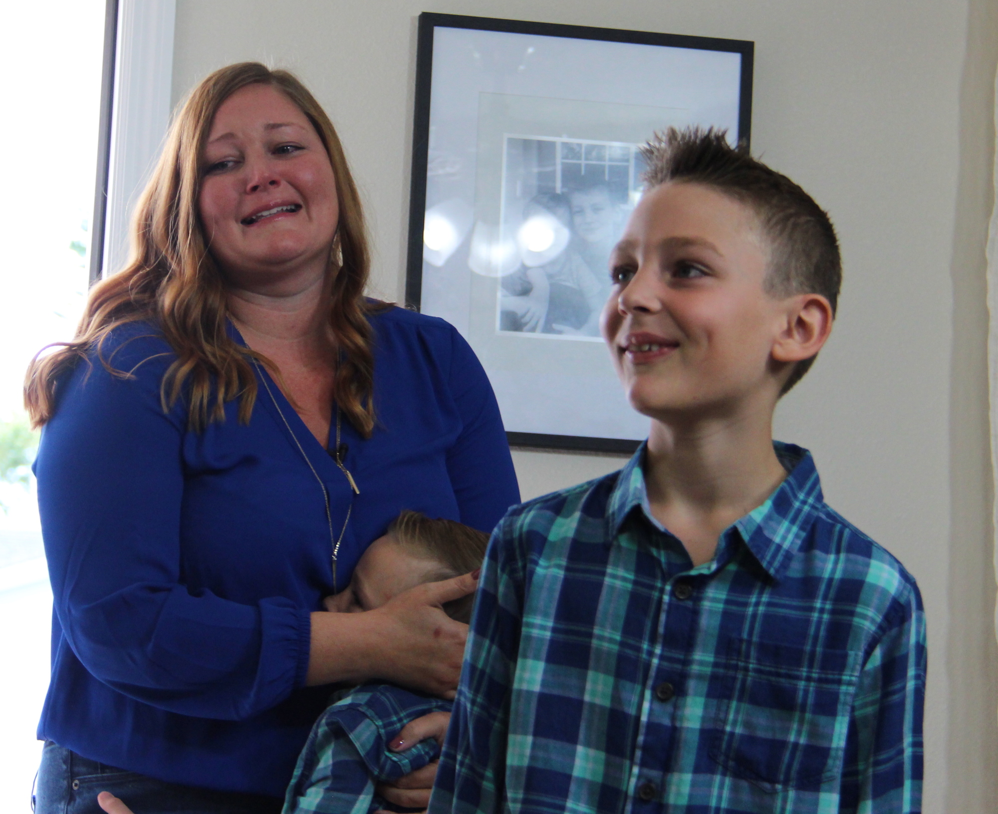 Chelsie Lloyd shed tears of joy and held her son, Aiden, when she saw her rebuilt and refurbished home for the first time. 