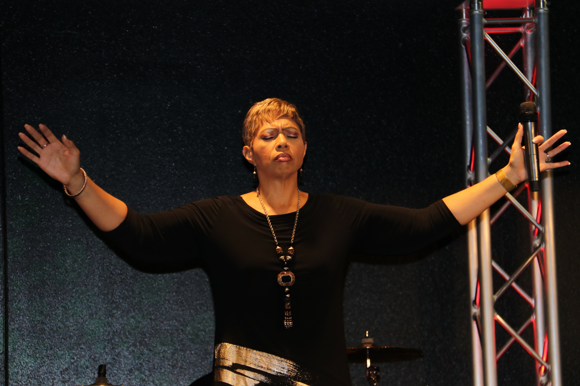 Pastor Teresa Price leads a prayer during a service at Overflow Worship Center.