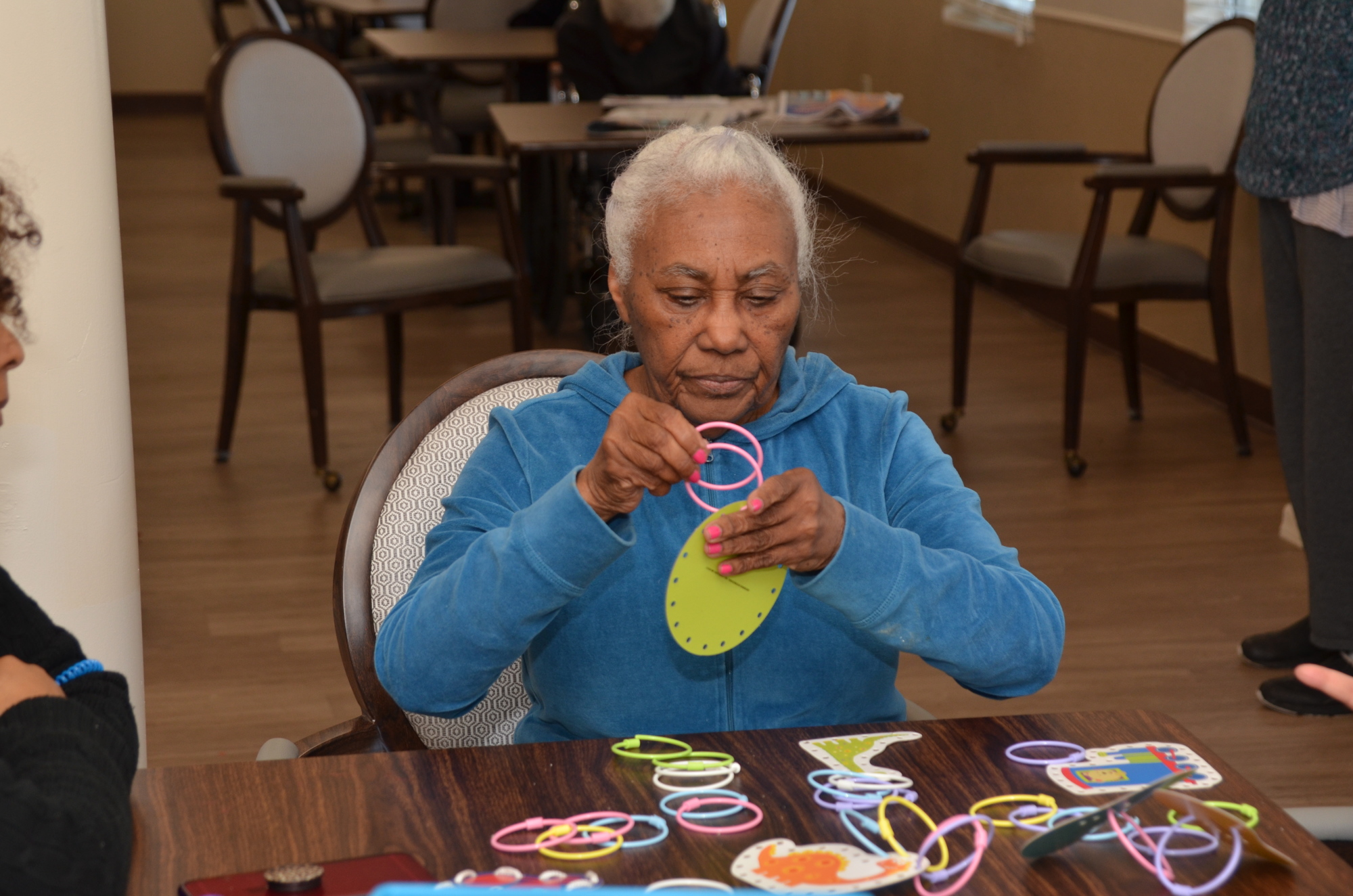 Residents such as Josefina Arus engage in hand-eye coordination activities in the memory-care building at Golden Pond Communities, in Winter Garden.