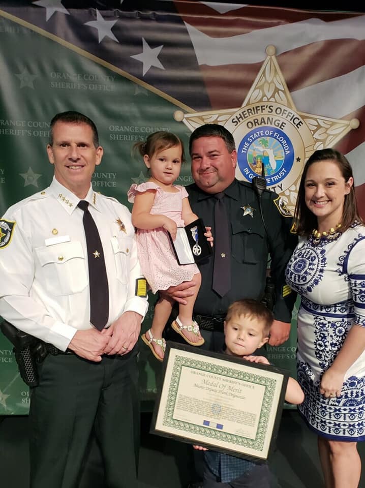 Orange County Sheriff John Mina awarded Master Dep. Del Guercio with the Medal of Merit, with his family in attendance.